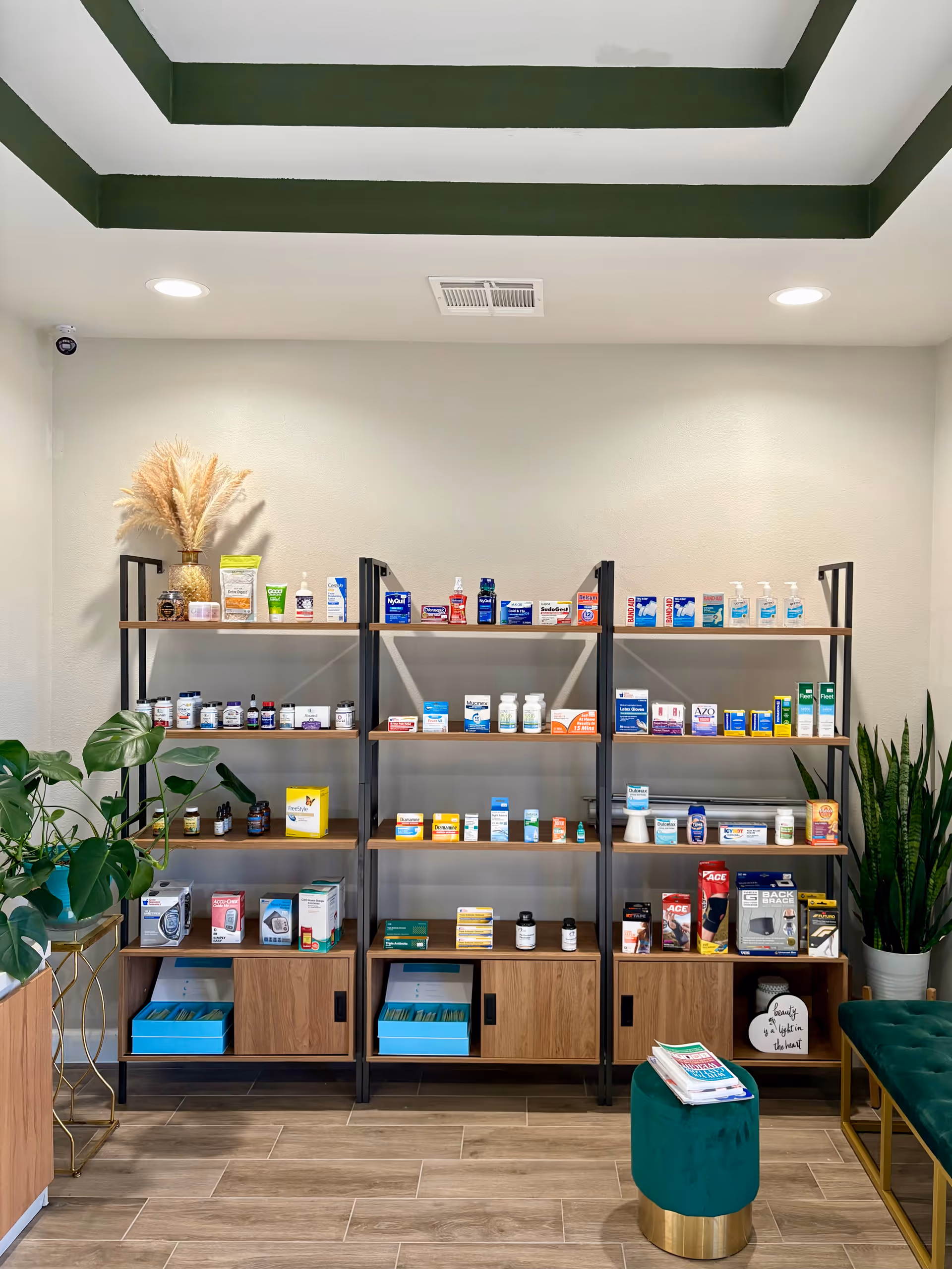 Interior of Sugarland Pharmacy & Wellness with tall shelves of medications, plants, and seating.