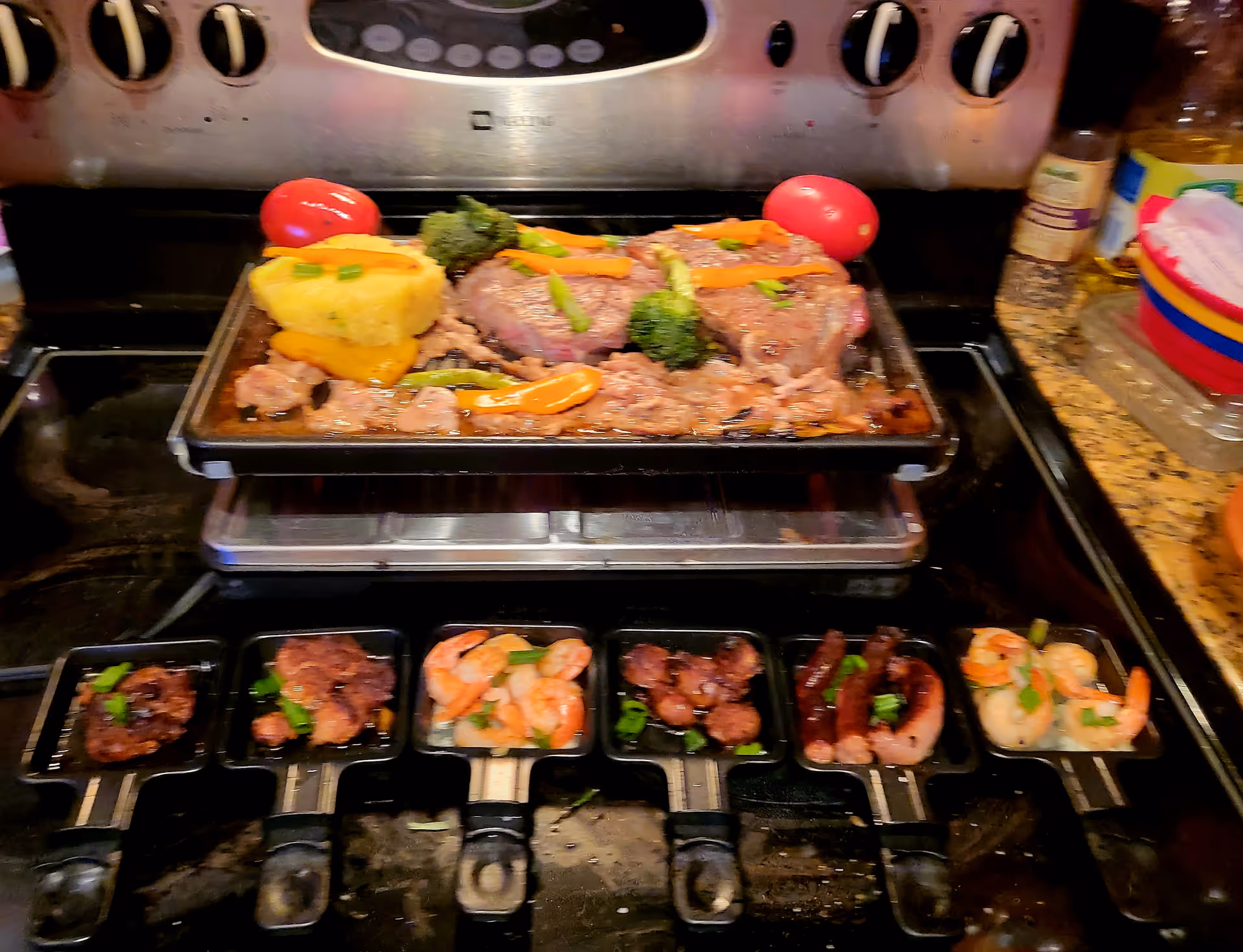A kitchen stove with a large roasting pan of meat and vegetables.