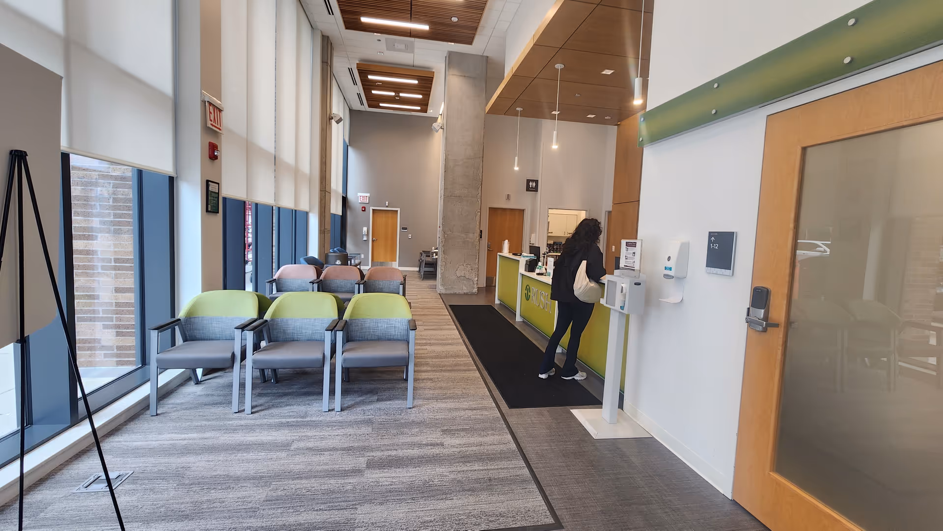 Modern lobby of Rush West Loop senior living with seating, windows, and a reception desk.