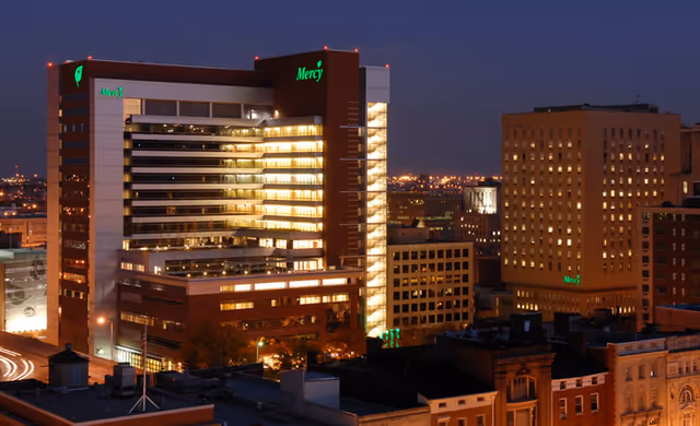Nighttime exterior of Mercy Personal Physicians Downtown building with illuminated windows.