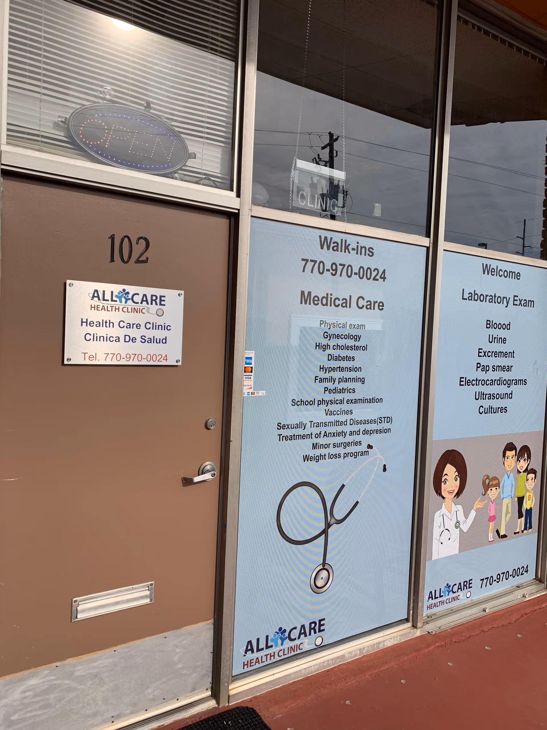 Brown storefront with large glass windows displaying medical care ads and an open sign.