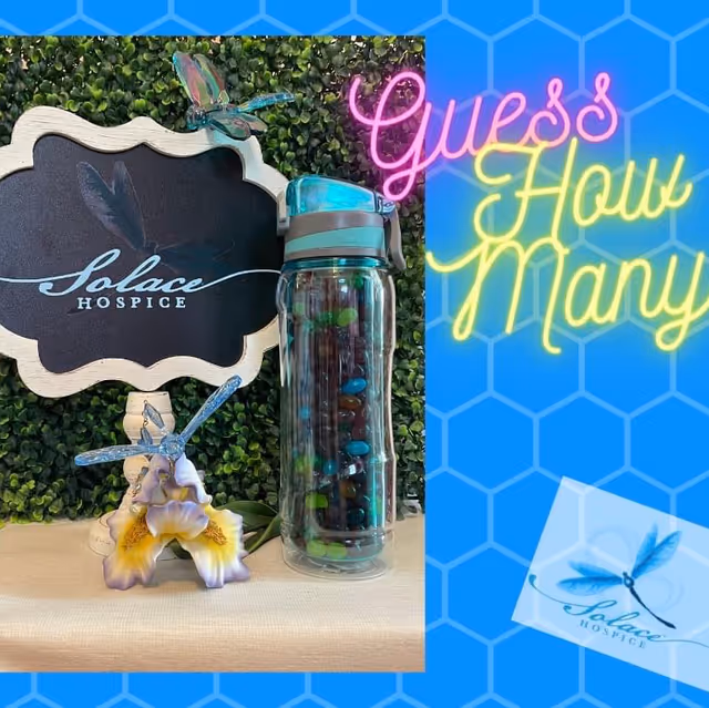 Indoor display featuring a Solace Hospice sign, a glass bottle, and decorative ornaments.