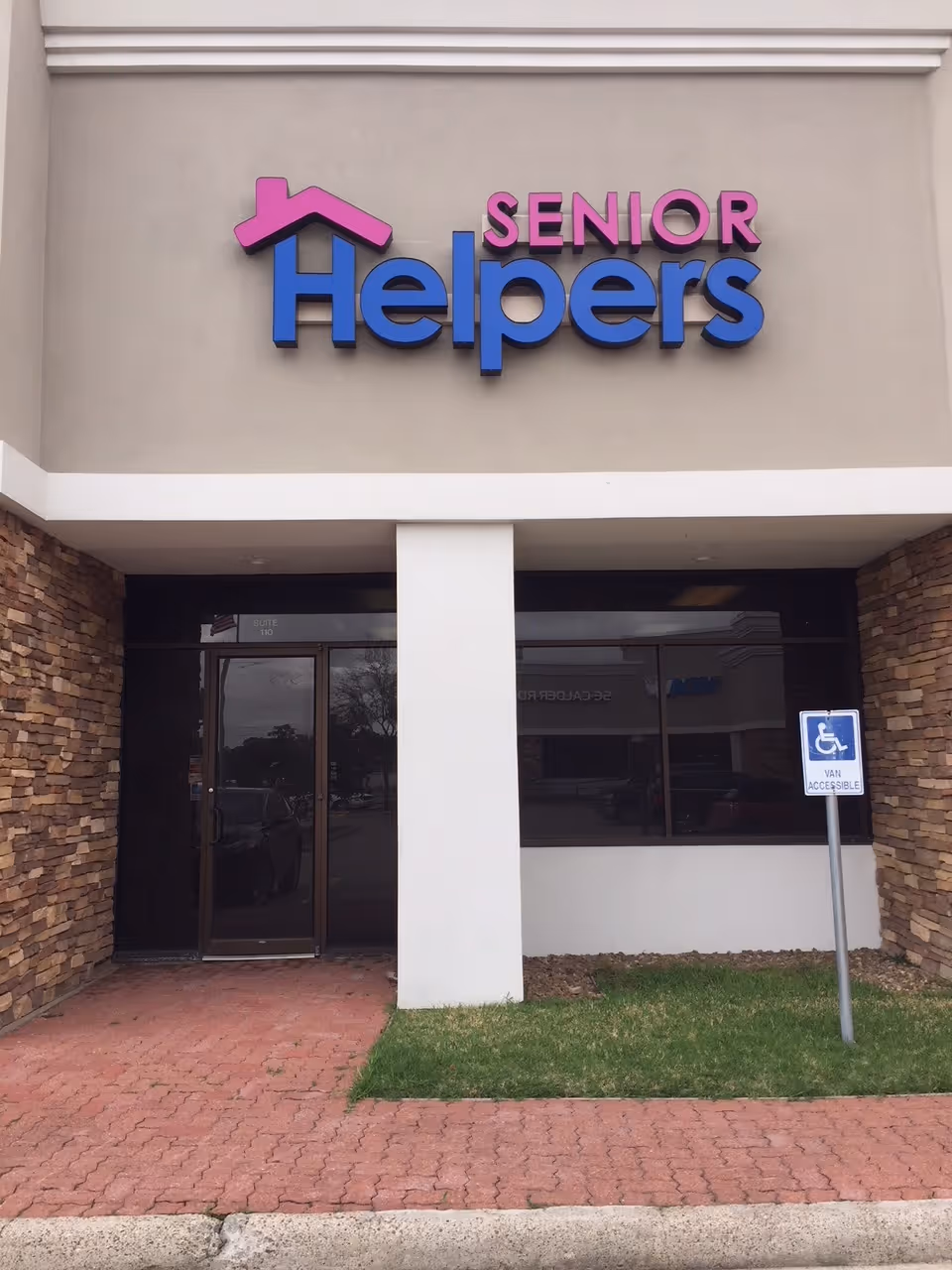 Front view of a Senior Helpers facility entrance with a large sign.