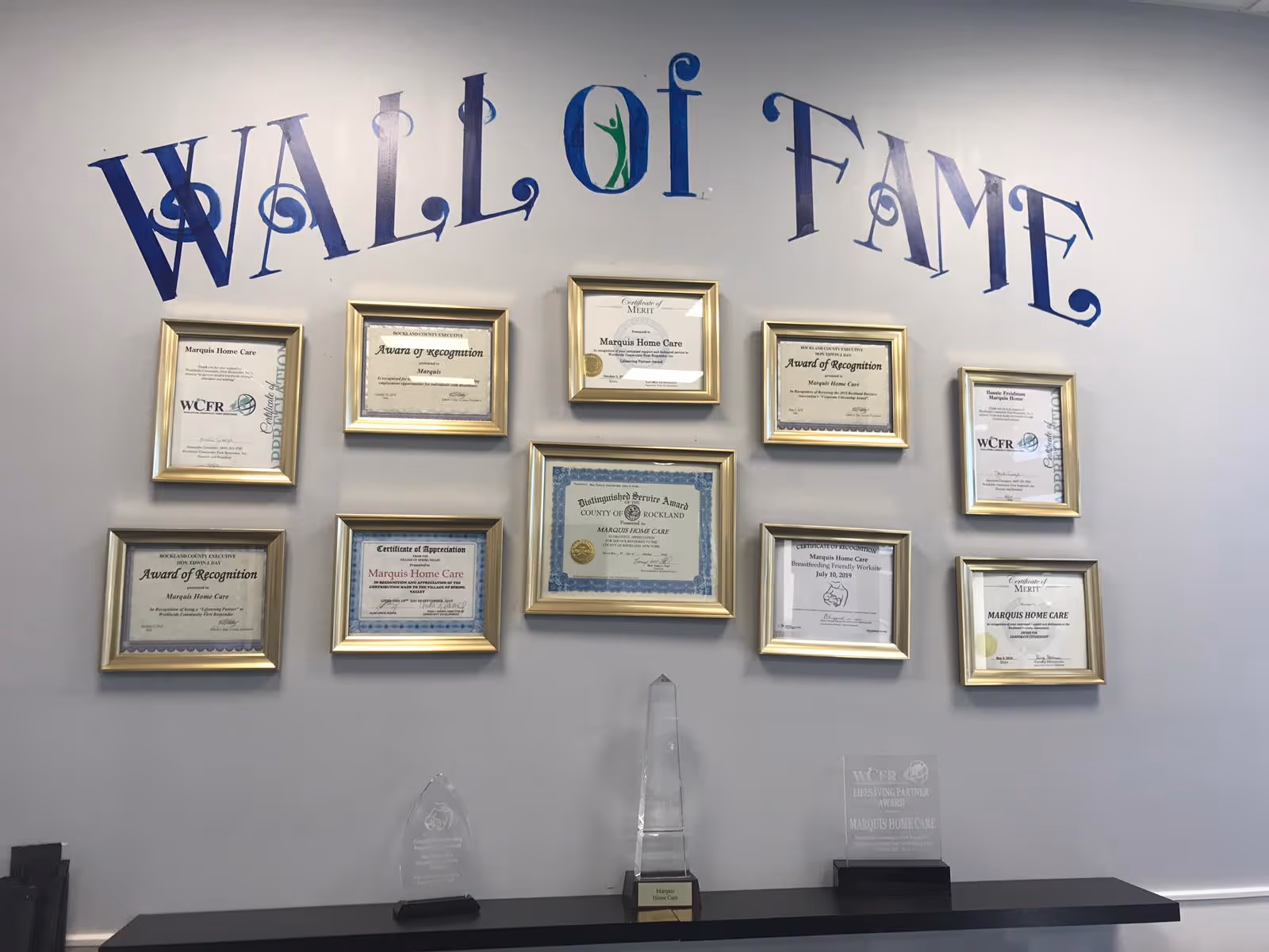 Interior wall featuring 'Wall of Fame' lettering and framed certificates.