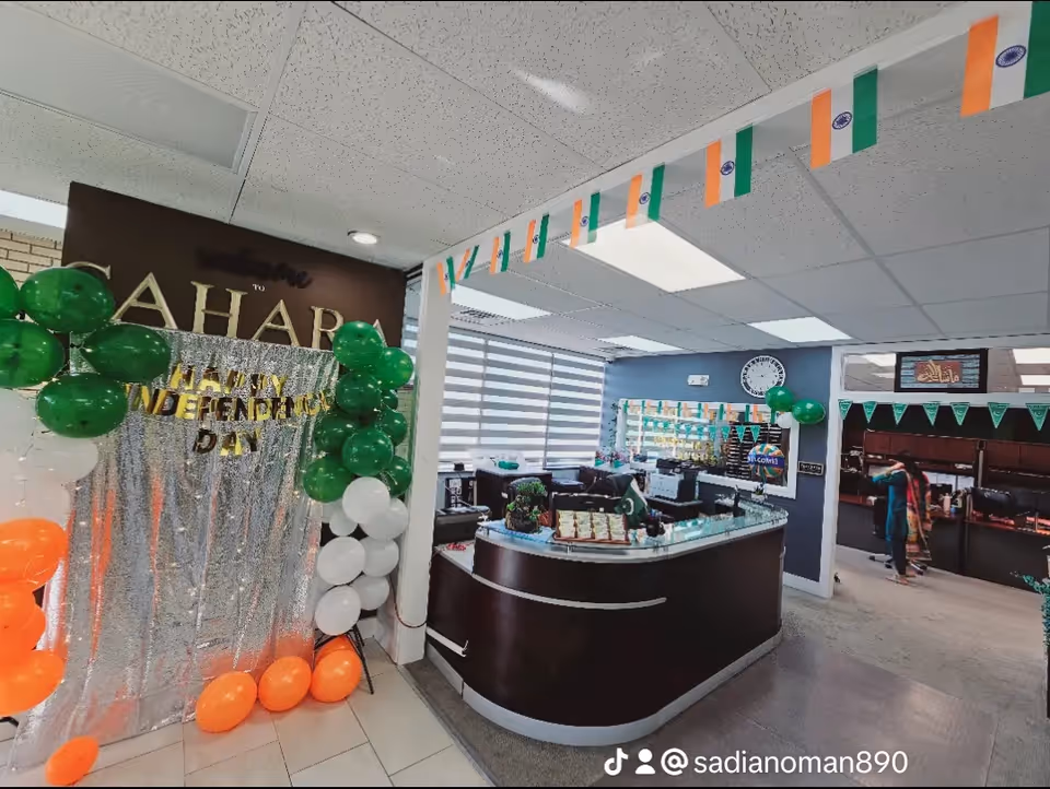 Reception area of Sahara Home Care with a curved front desk, balloons, and flags.