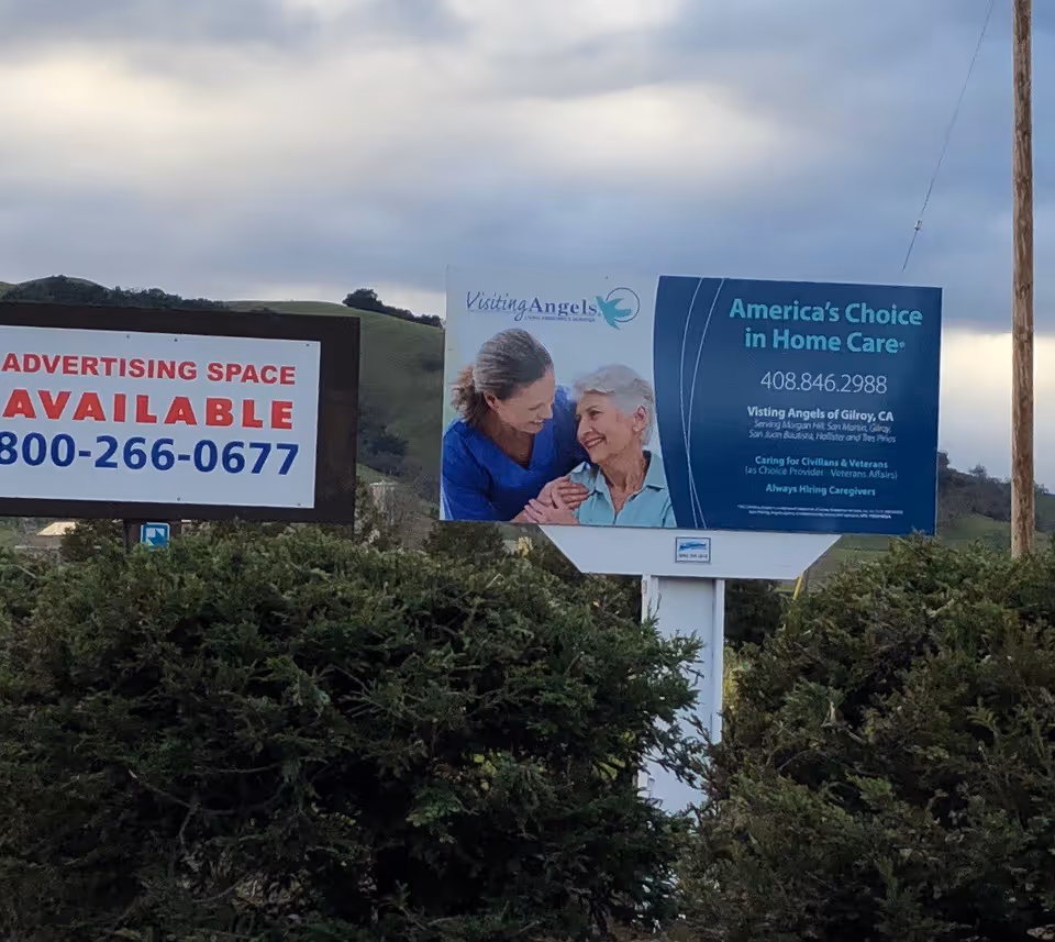 Outdoor billboard advertising Visiting Angels home care featuring two elderly people embracing.