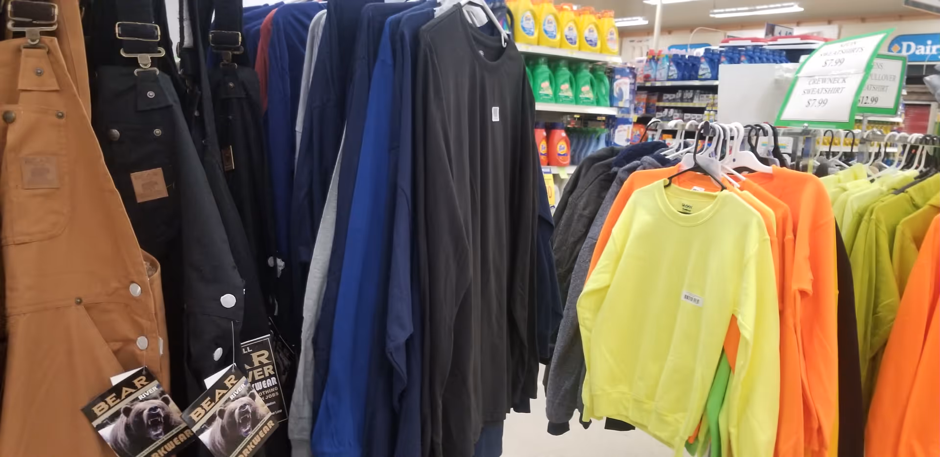 Clothes on racks in a Discount Drug Mart store, neon shirts and jackets displayed