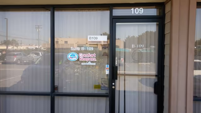 Exterior entrance to Comfort Keepers Home Care with glass doors and Suite B-109.