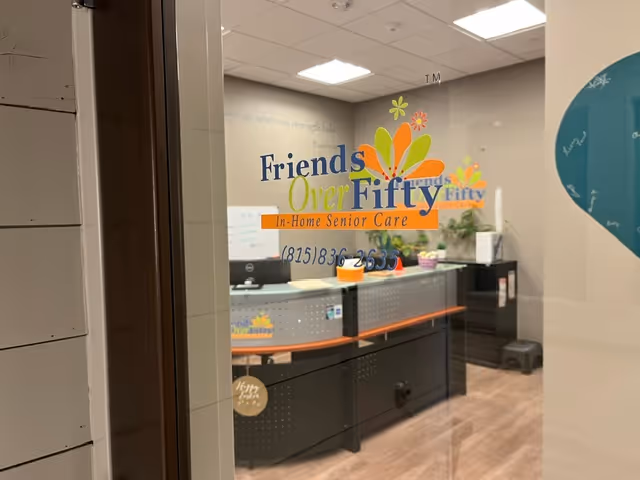 Interior reception area of Friends Over Fifty Senior Care with a front desk and signage.