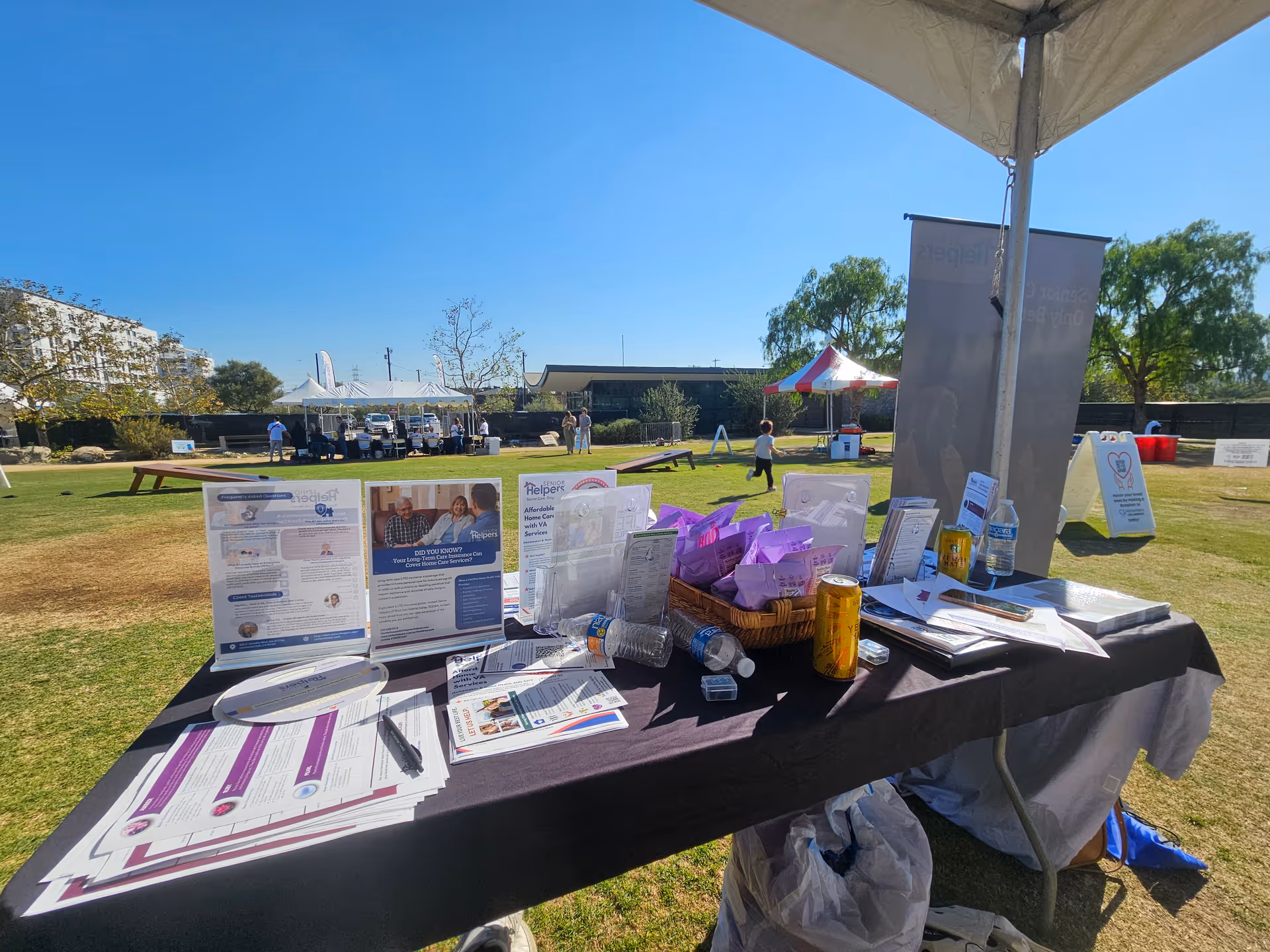 Outdoor health fair at Senior Helpers with tables and brochures.
