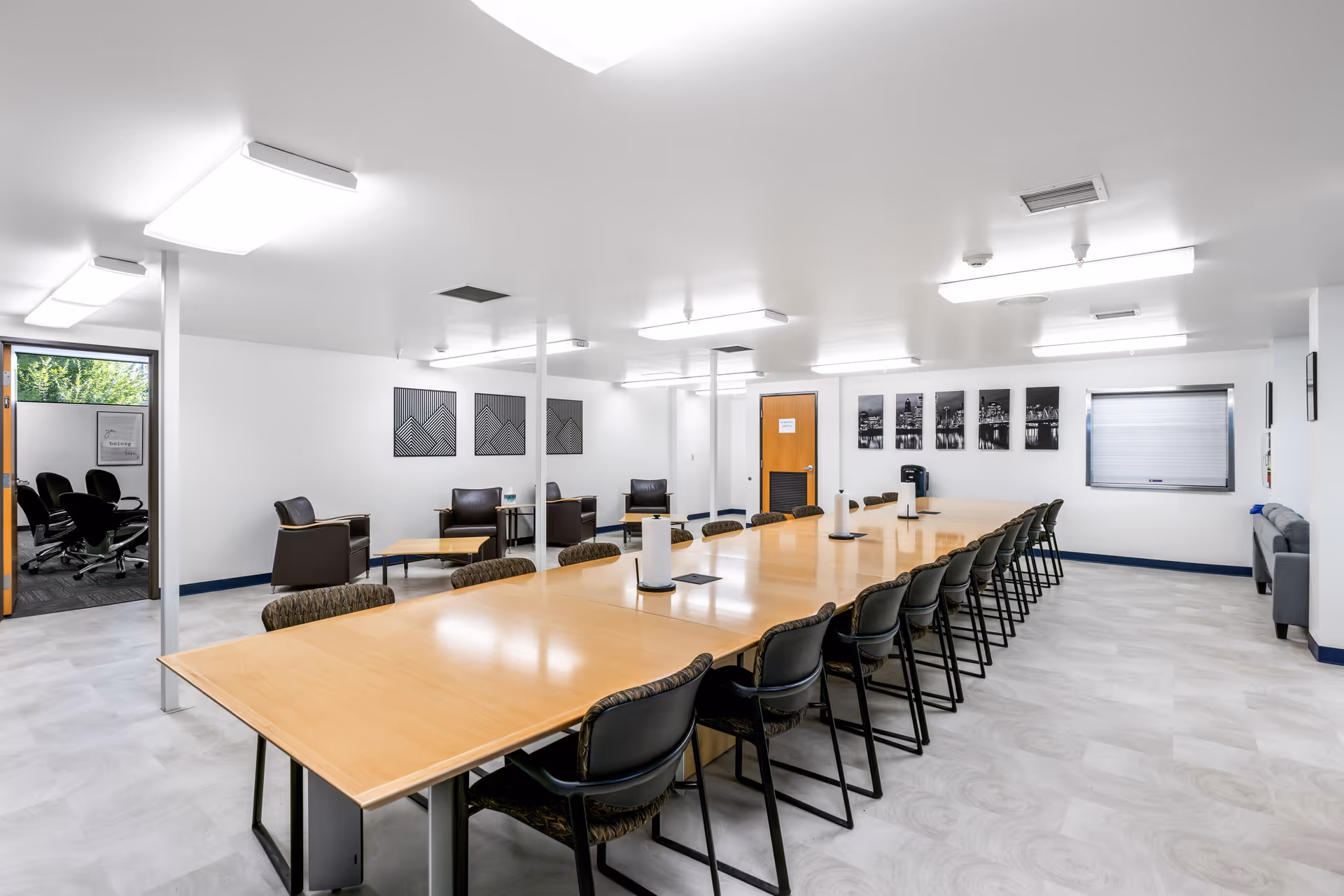 Large conference room with a long table, many chairs, and lounge seating.