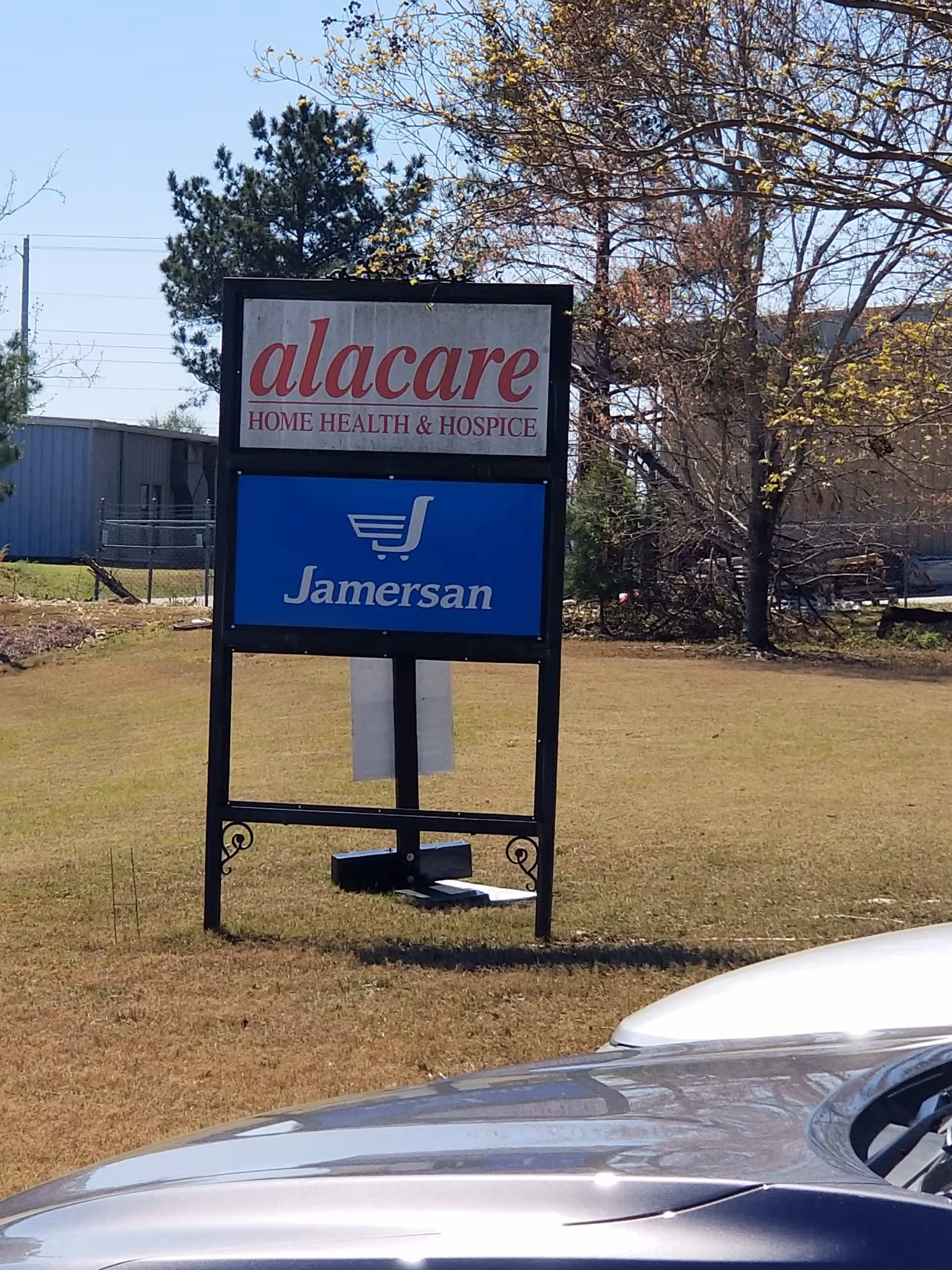 Outdoor signboard advertising alacare Home Health and Hospice with a blue Samersan panel.