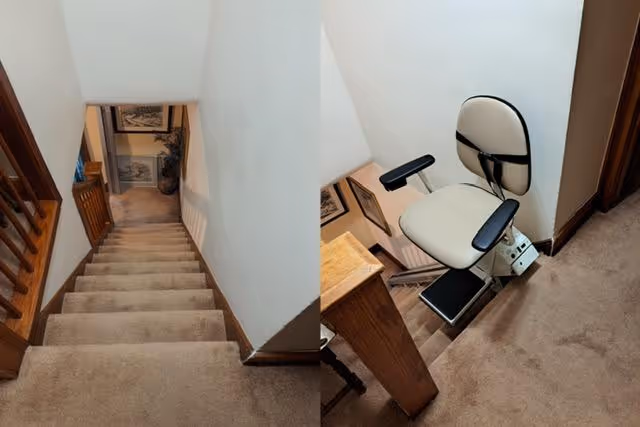 Interior stairwell featuring a mounted chair lift beside the carpeted stairs.