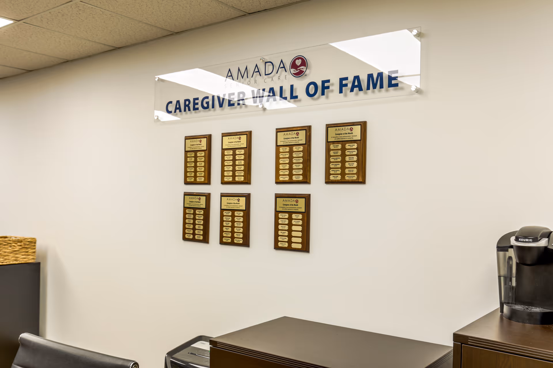 Interior at Amada Senior Care lobby displaying a Caregiver Wall of Fame sign and plaques.
