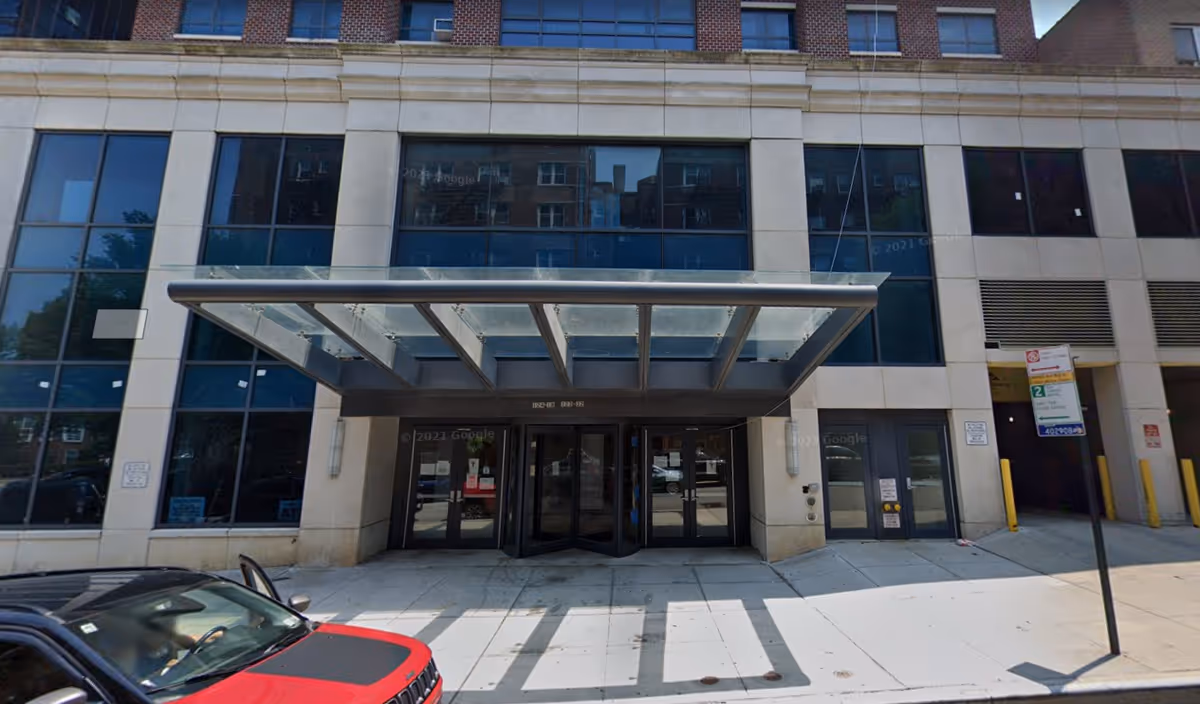Facade of Senior Helpers facility with glass front entrance and metal canopy.