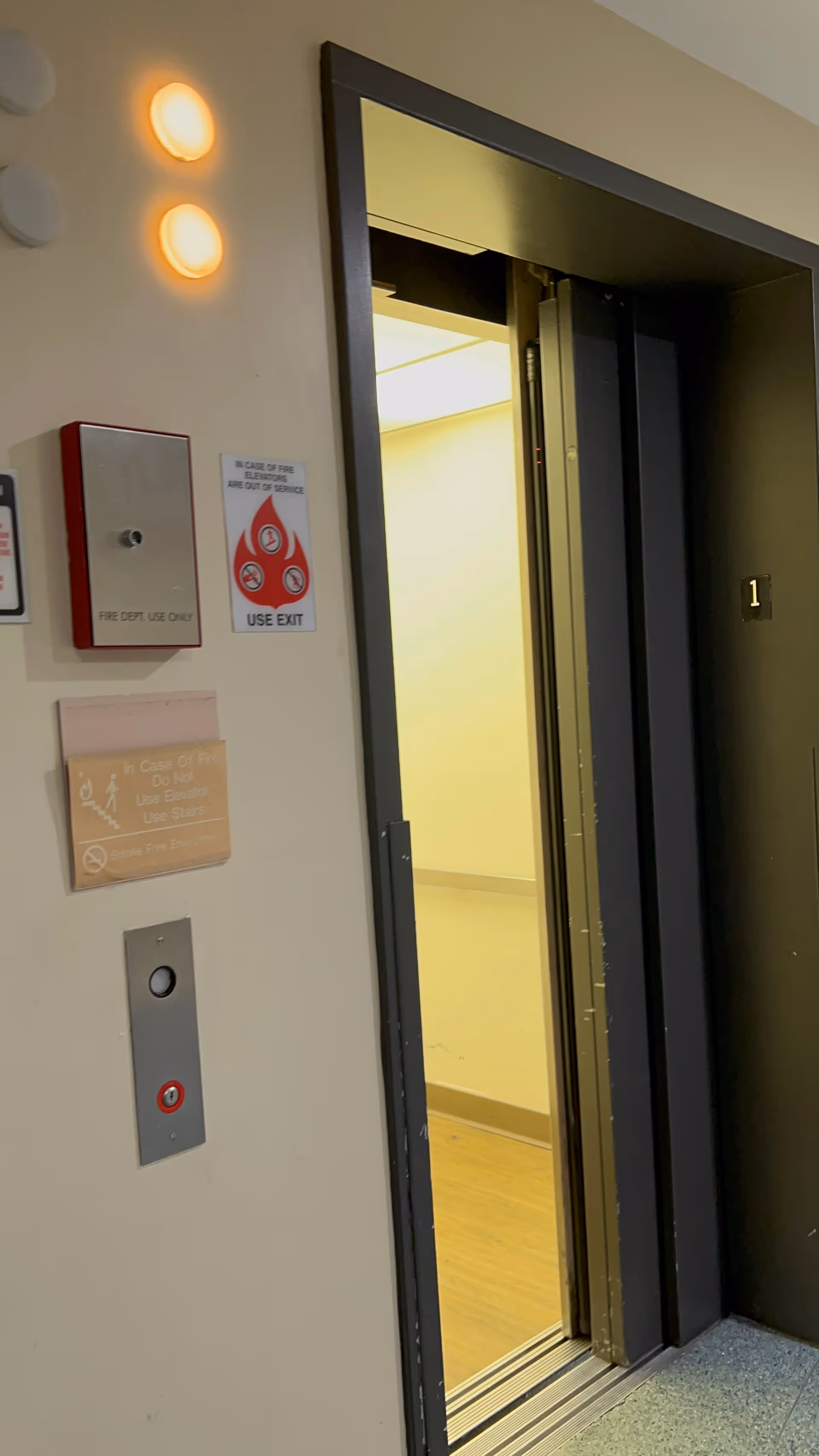 Elevator doors open in a hallway of a senior living facility.