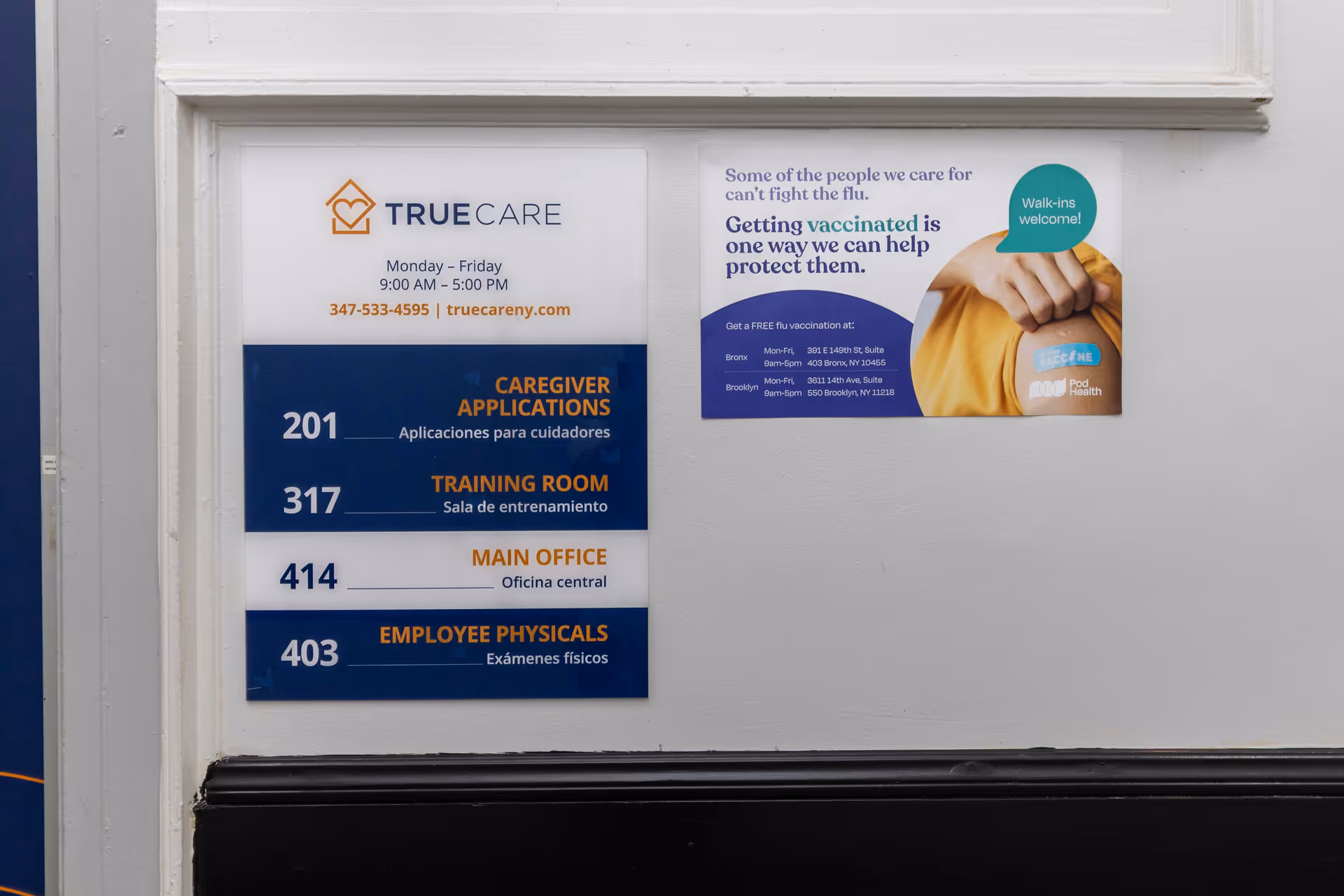 Interior wall with TrueCare signage and a blue directory panel listing office numbers.