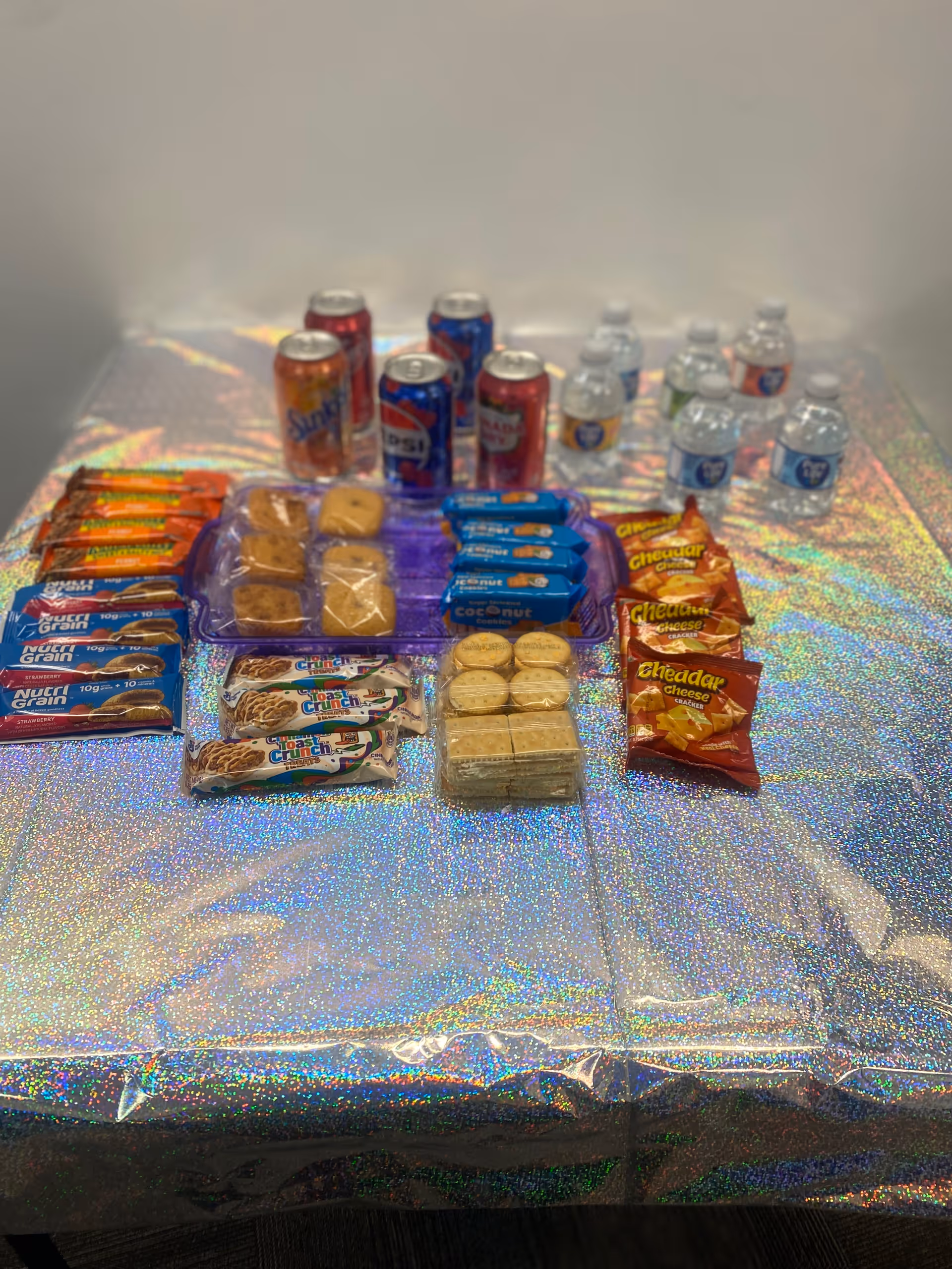 Assorted snacks and beverages neatly arranged on a holographic table.