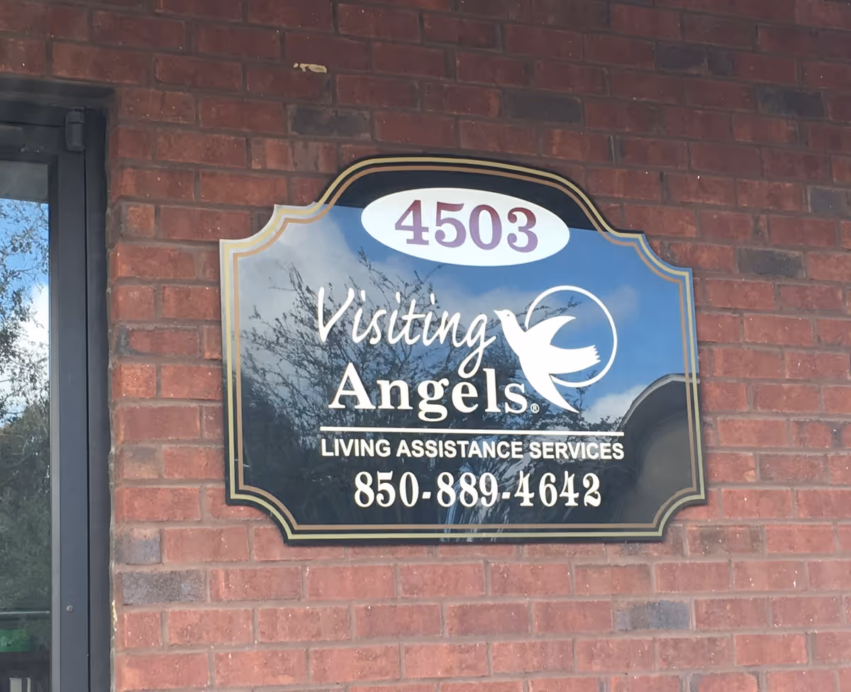 Exterior brick wall with a blue Visiting Angels sign showing 4503 and phone number.