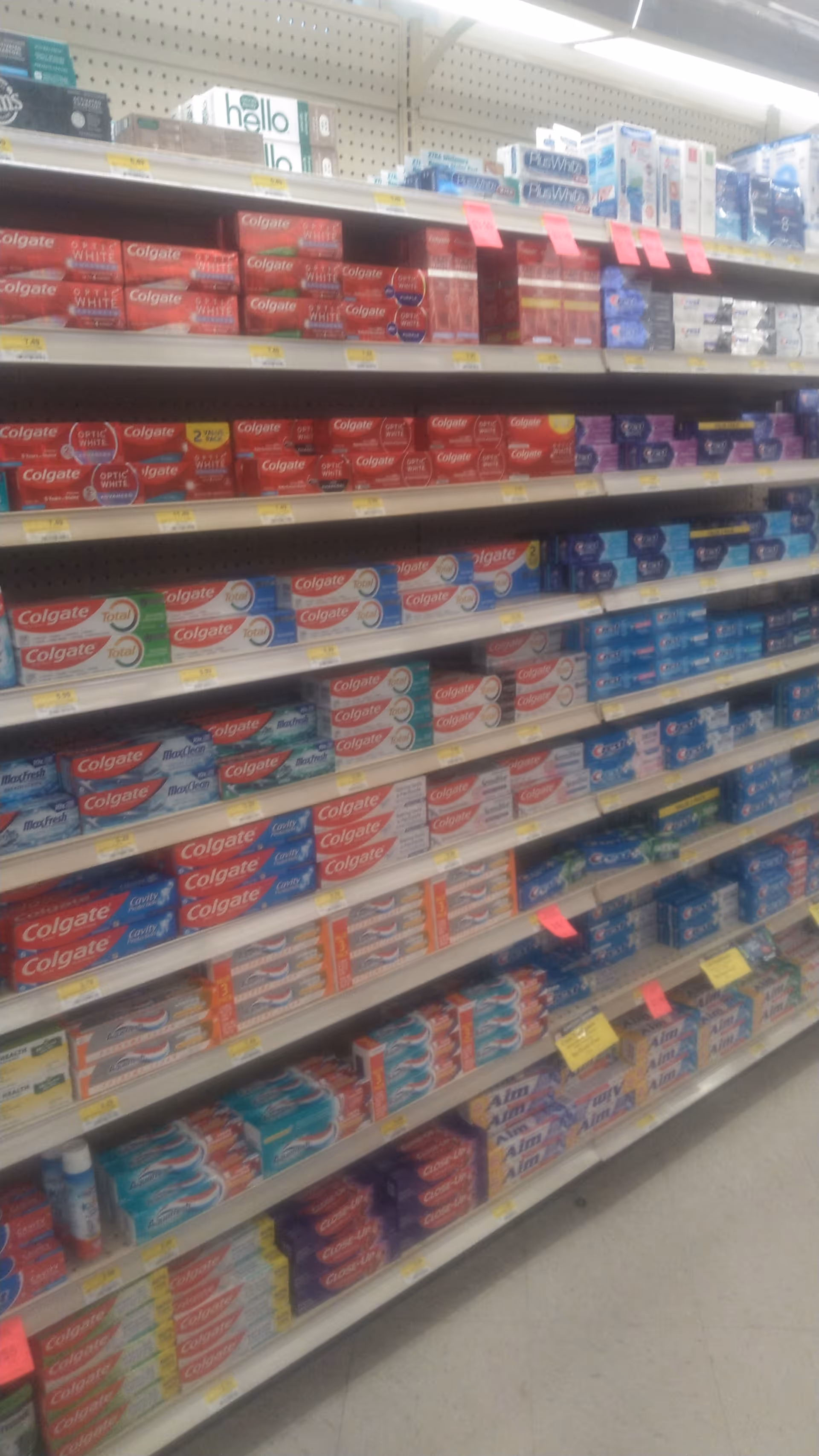 Aisle of toothpaste boxes on shelves at Discount Drug Mart.