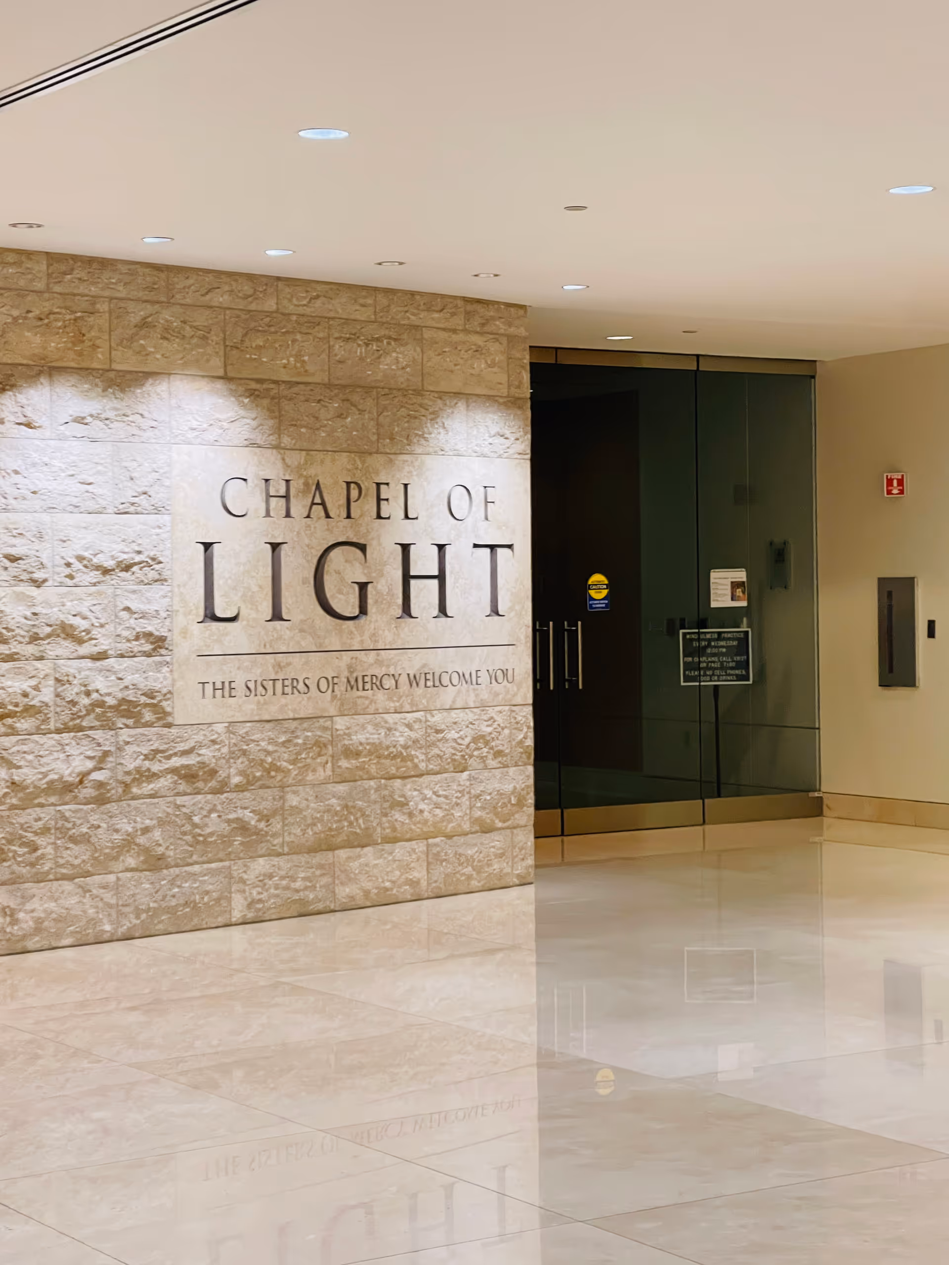 Mercy Medical Center interior featuring Chapel of Light sign on a stone wall.