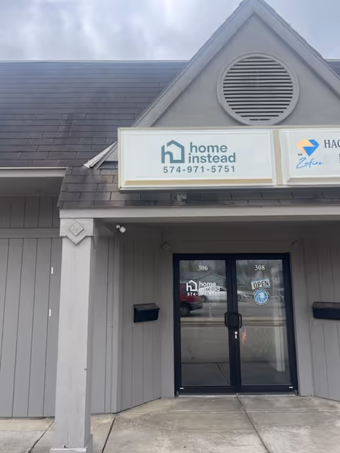 Exterior view of a Home Instead facility entrance with double doors.
