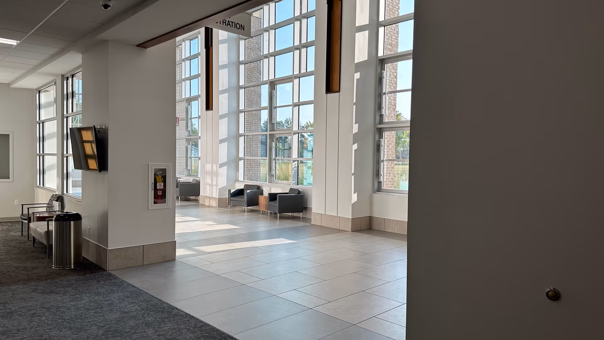 Bright lobby of a senior living facility featuring large windows and seating.