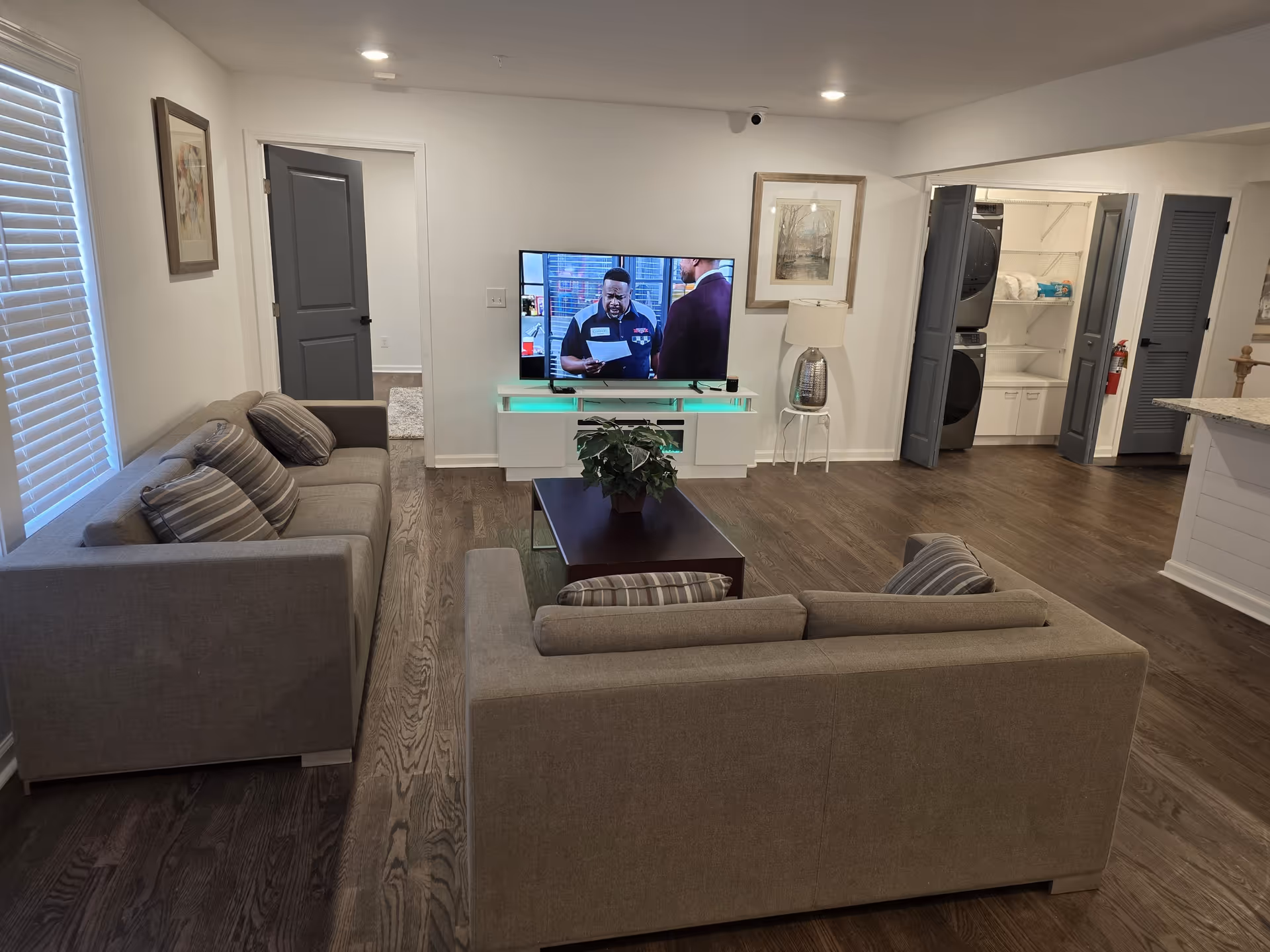 Cozy modern living room with two gray sofas, coffee table, and TV.