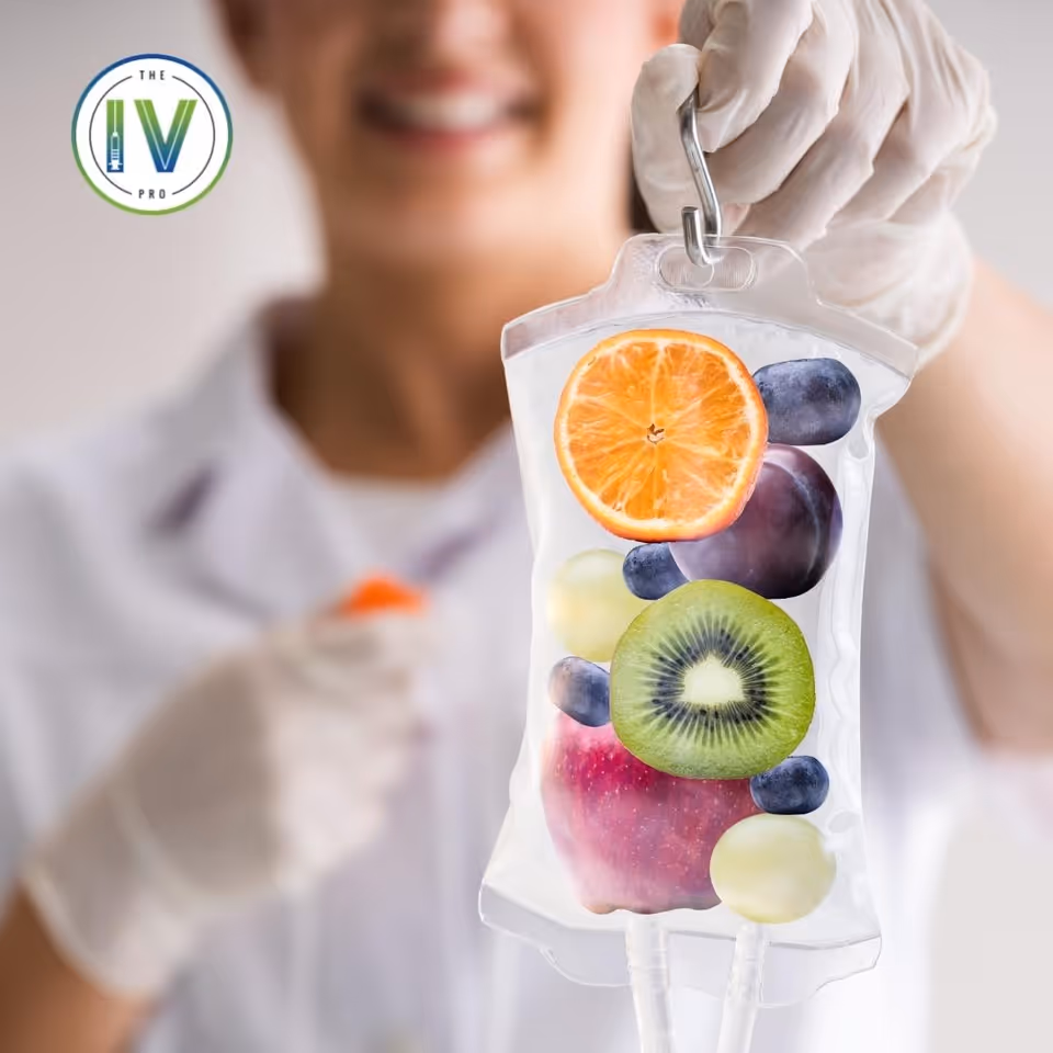Gloved healthcare worker holds an IV bag filled with fruit, with The IV Pro logo visible.