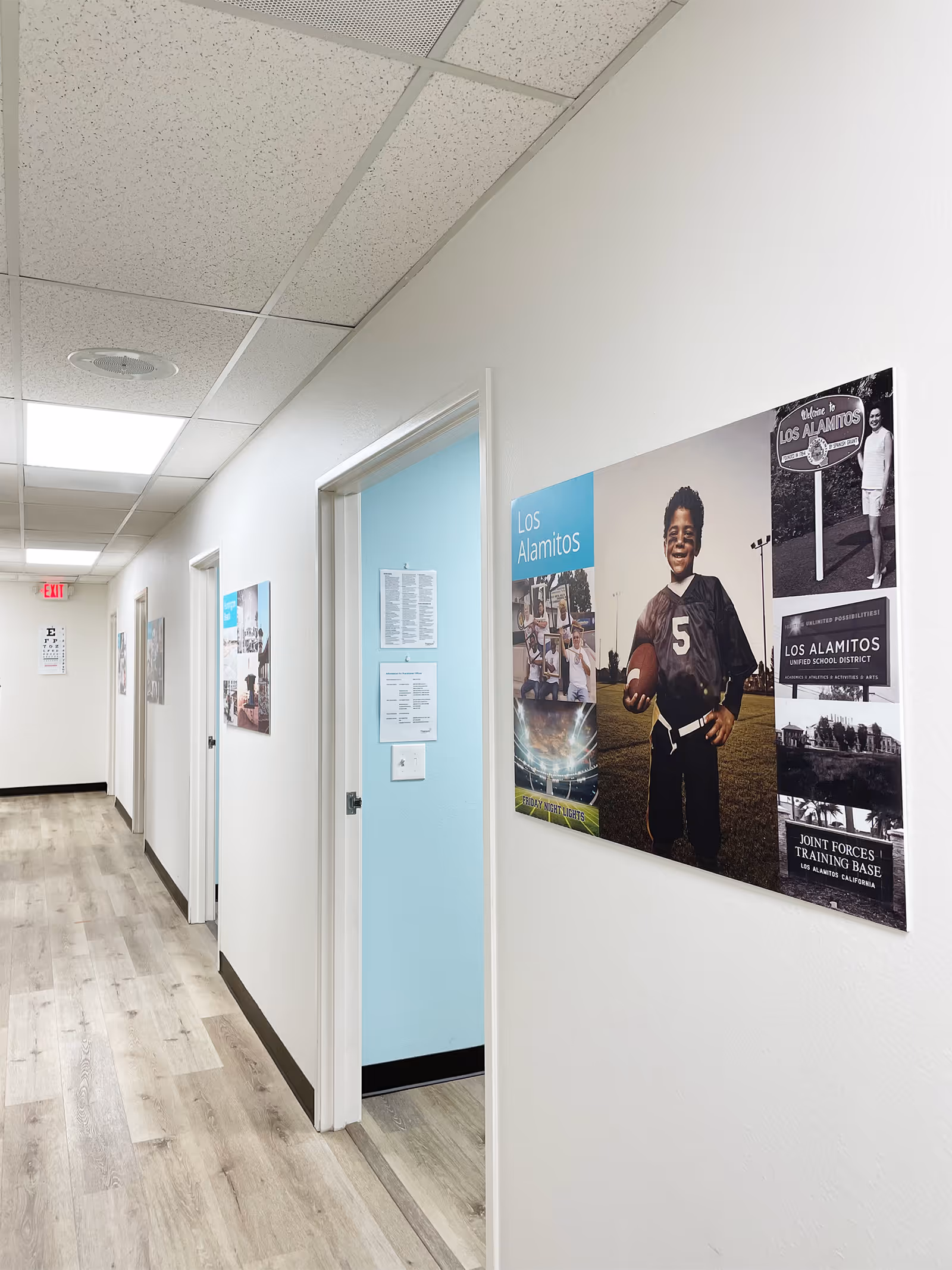 Bright hallway in a senior living facility with wall posters.