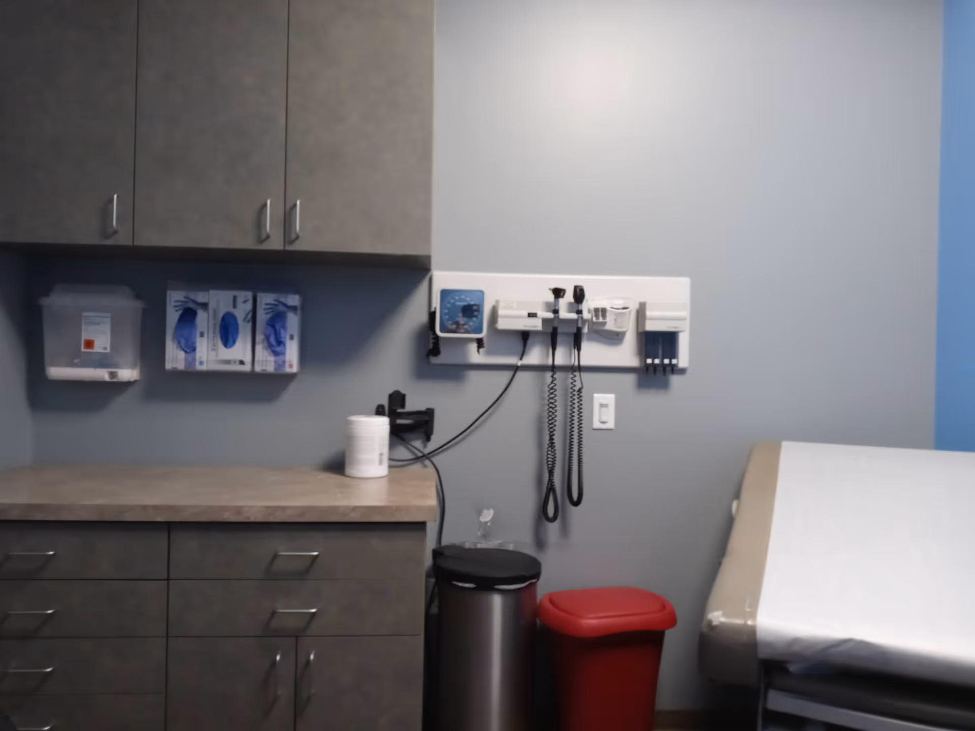 Examination room in a senior living facility with medical equipment and an exam bed.