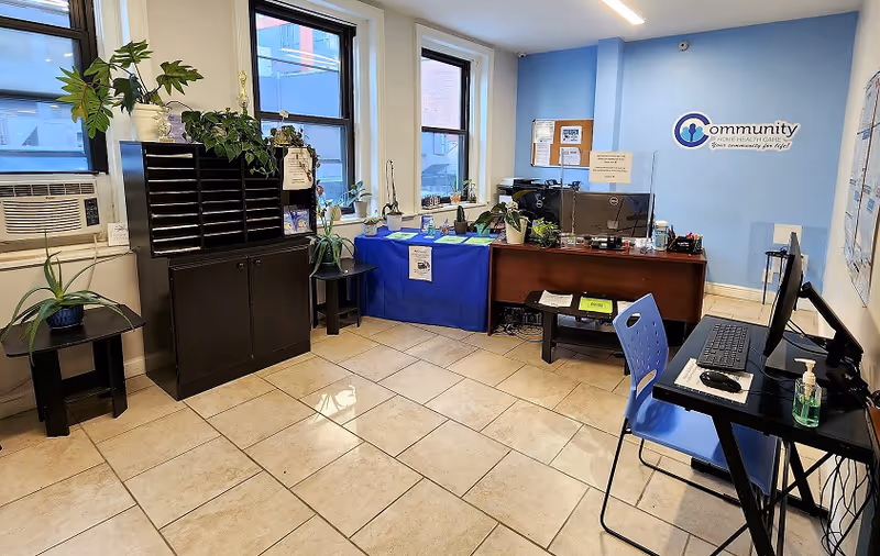 Recruiting office reception area of Community Home Health Care with desks and plants.