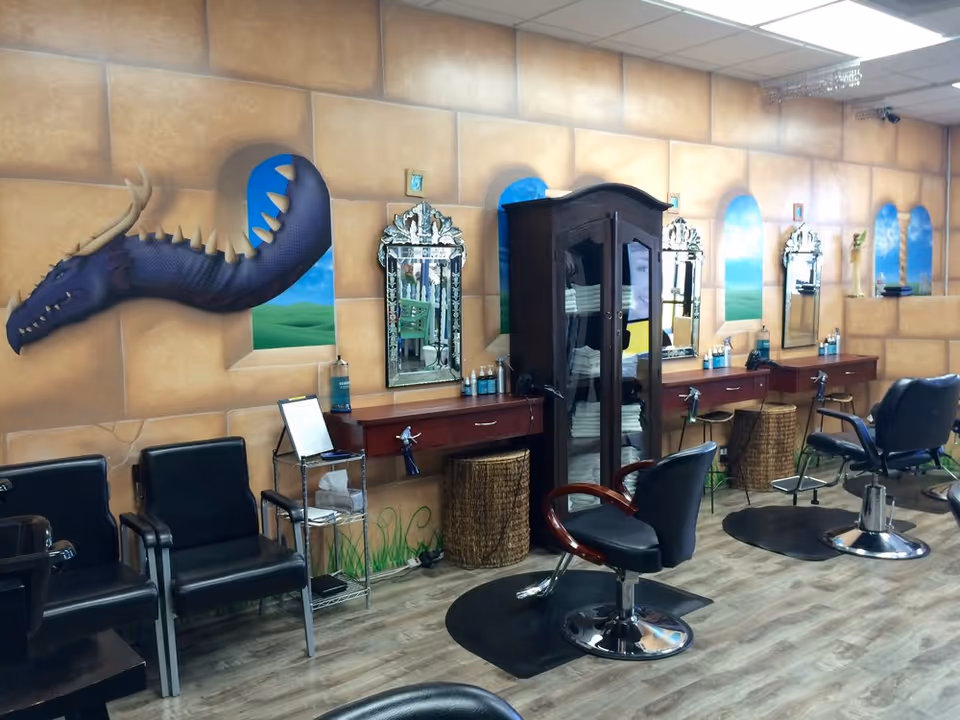 Hair salon inside a senior living facility with mirrors, chairs, and dragon mural.