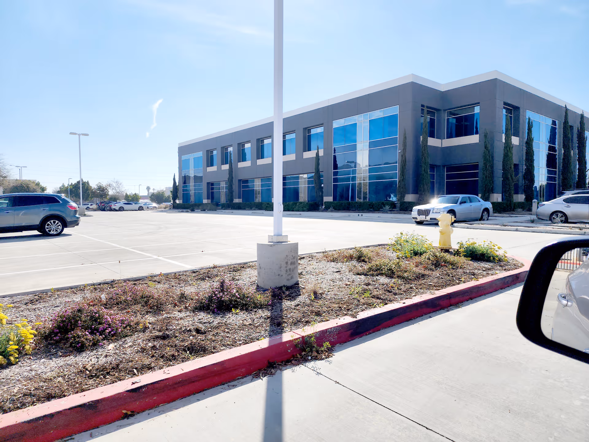 Exterior view of Suncrest Hospice Riverside building with parking lot and landscaping
