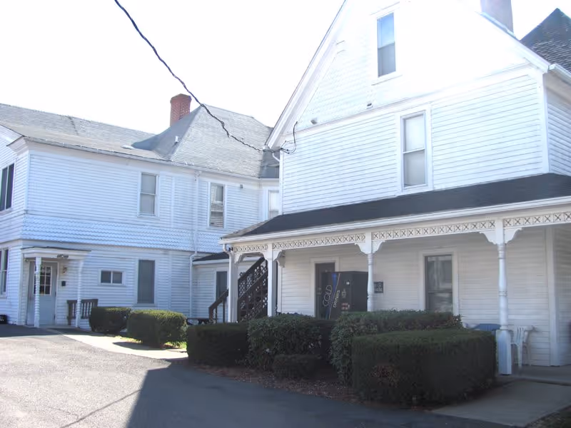 Exterior view of Smith's Personal Care Home, a white building with a porch.