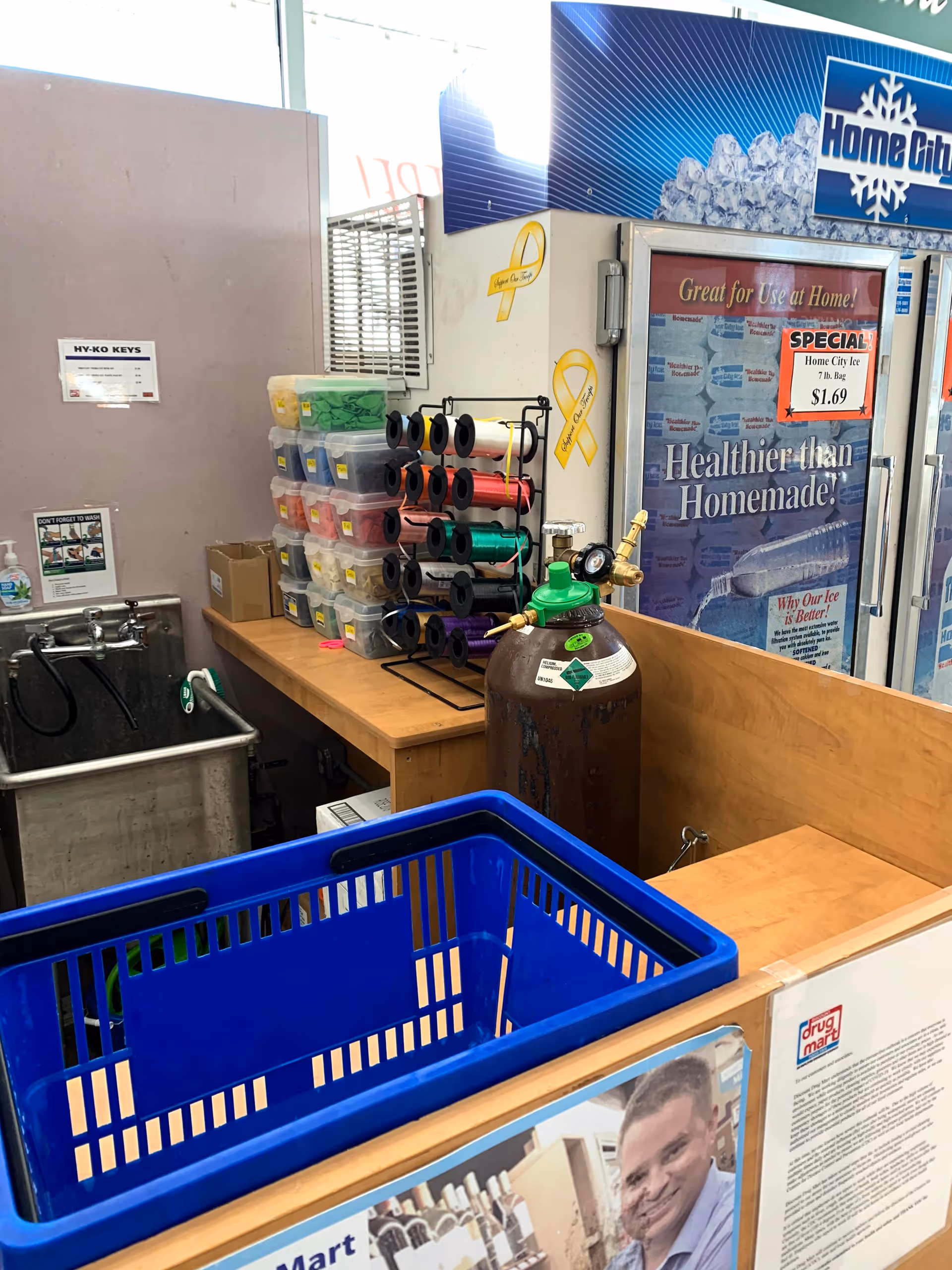 Interior of a Discount Drug Mart checkout area with a blue basket and medical equipment.