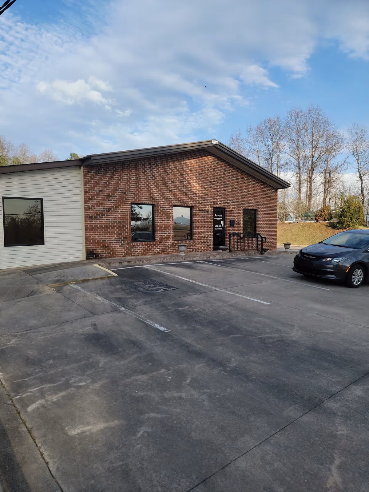 Brick exterior of Addus HomeCare facility with entrance and parking.
