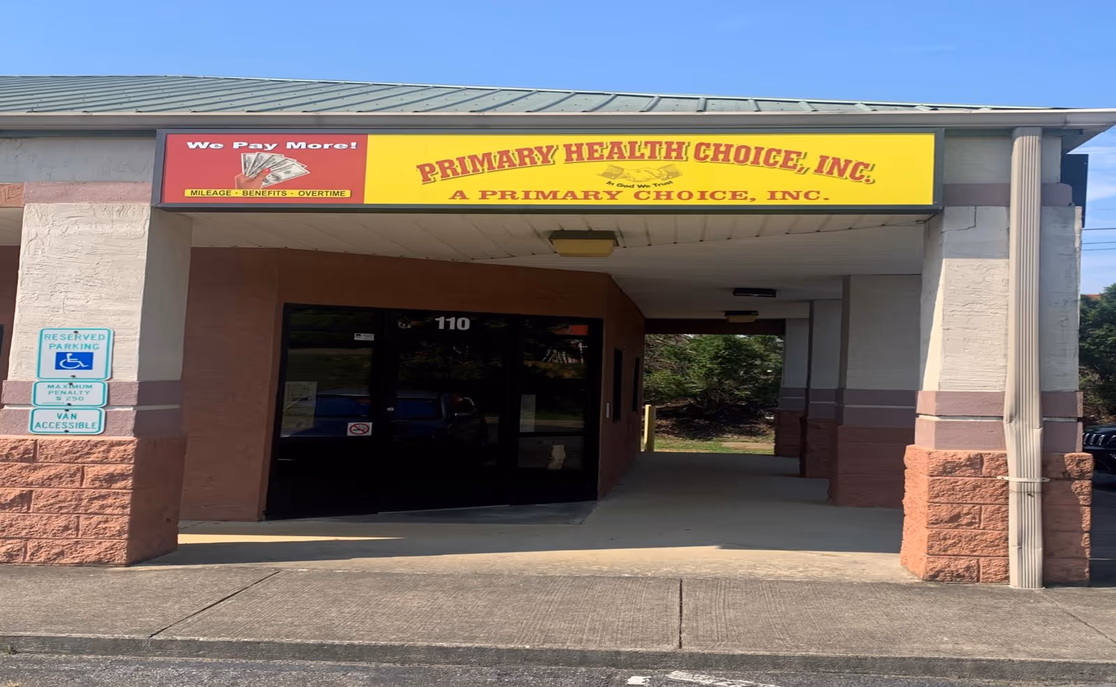 Facility entrance with a bright yellow Primary Health Choice sign.