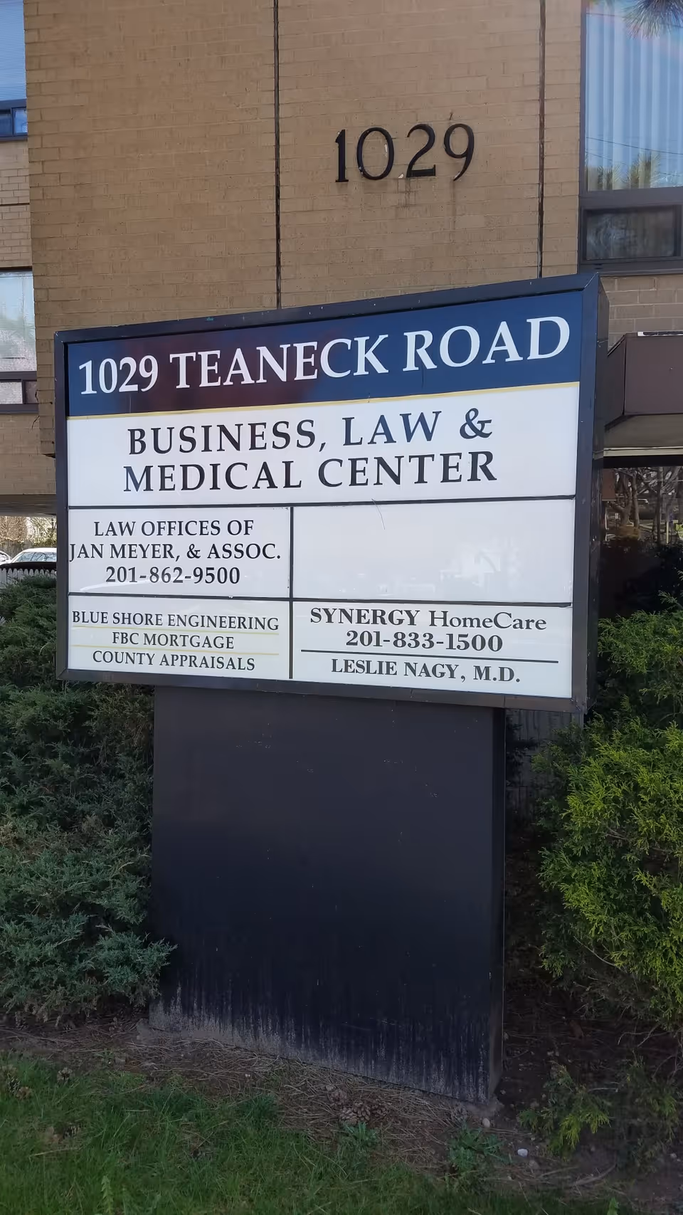 Brick building front with a large sign reading 1029 Teaneck Road.