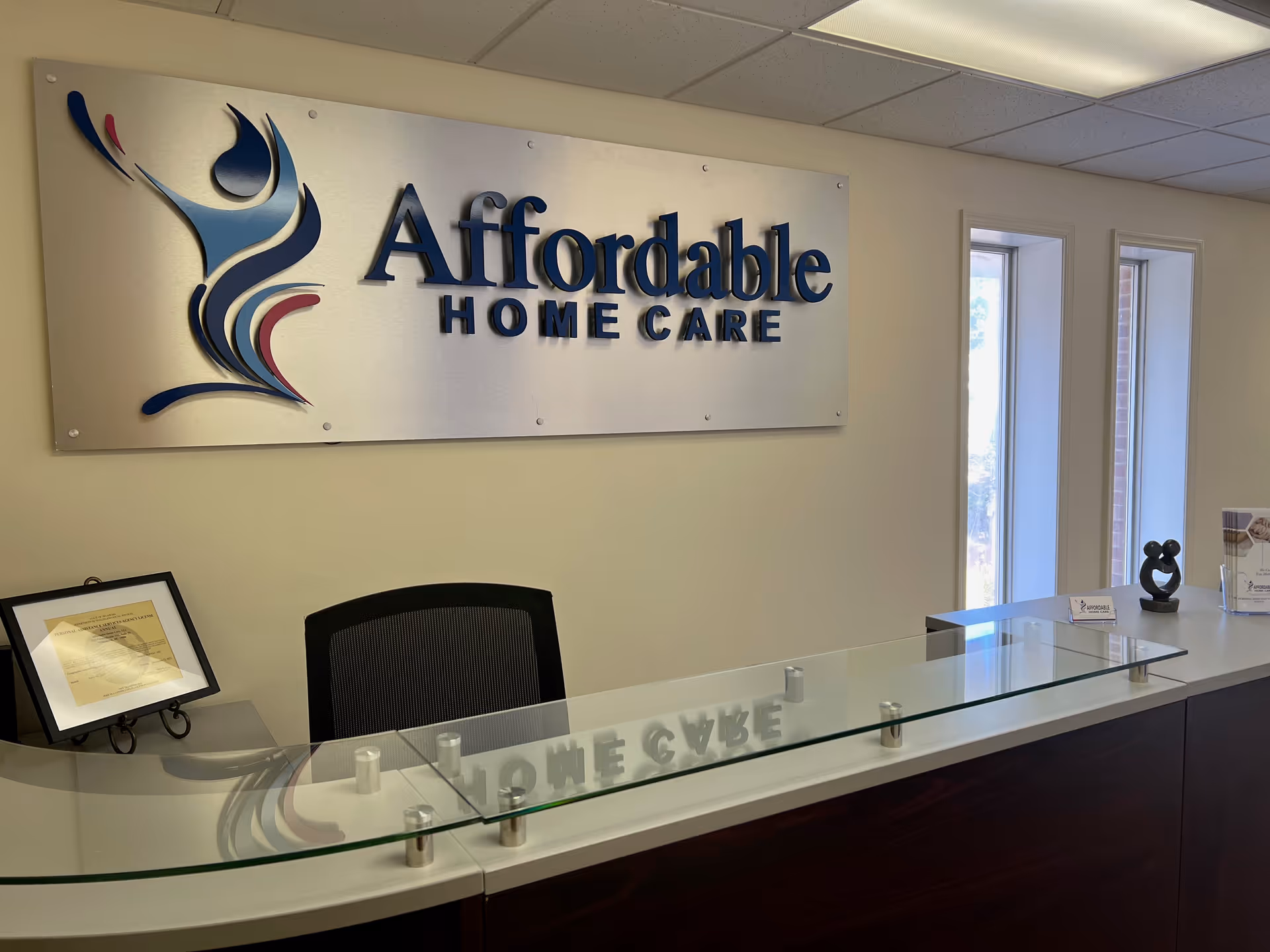 Reception desk in a facility lobby with Affordable Home Care sign.