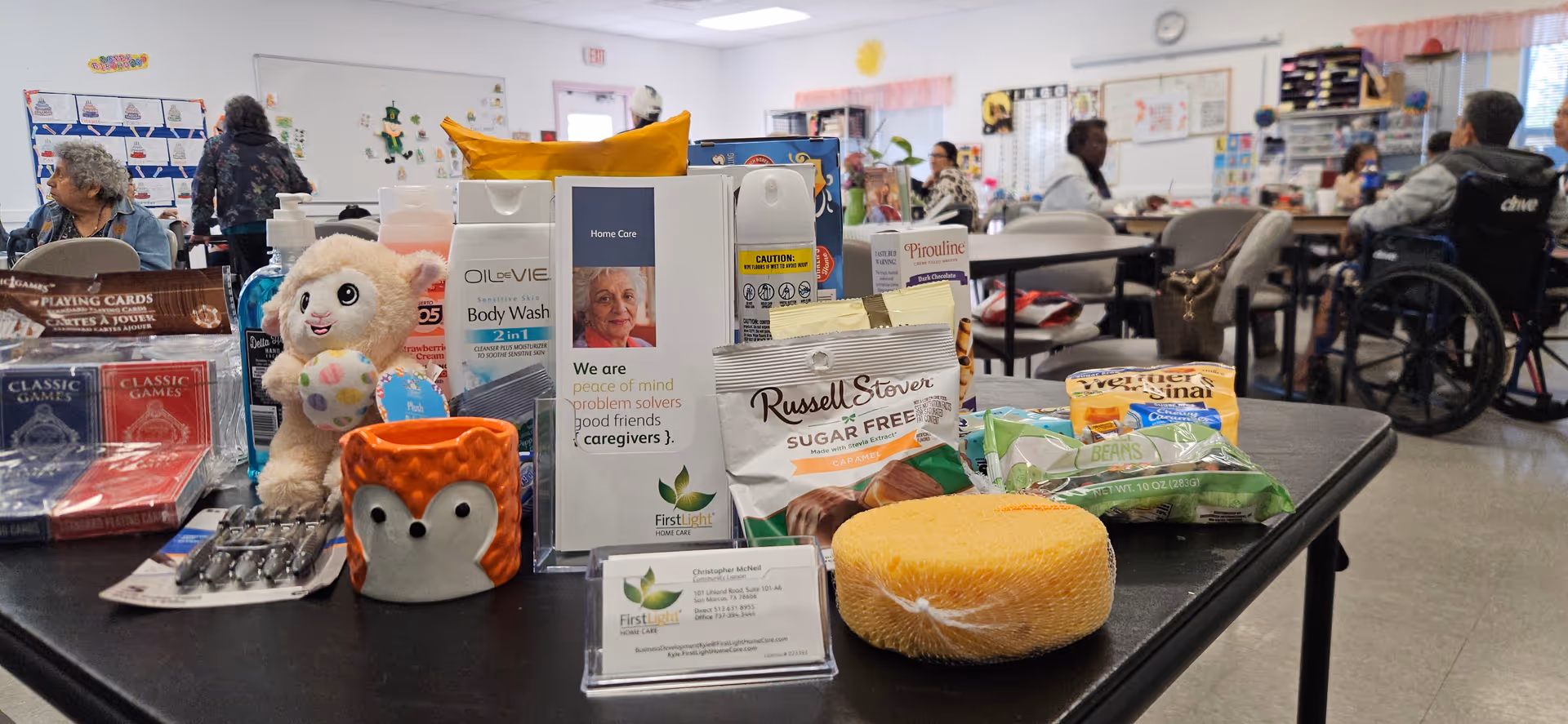 Table in bright activity room displays care products and snacks.