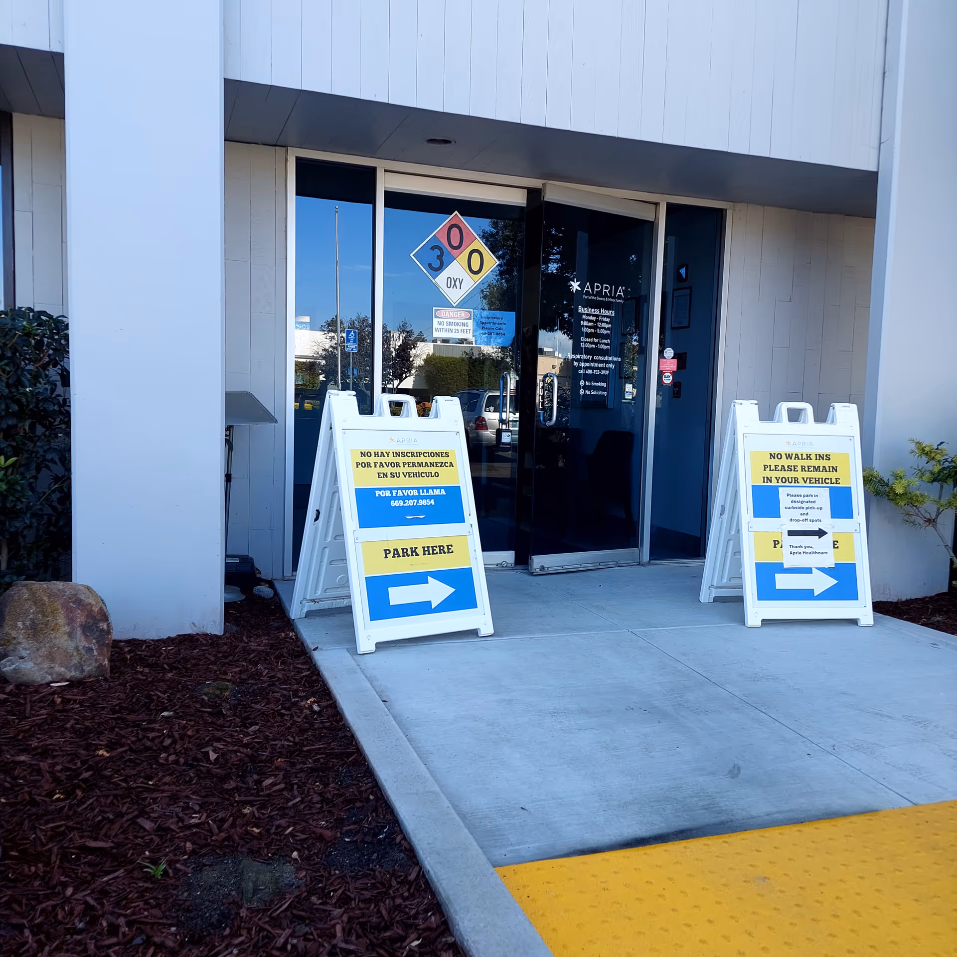 Apria Healthcare entrance sits on the building front with glass doors and signs.