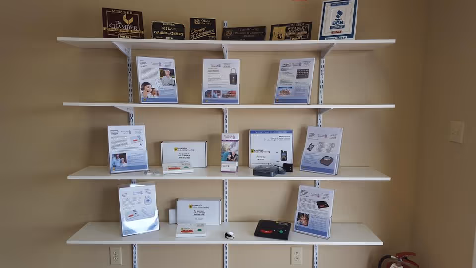 Interior wall with white shelves displaying brochures and plaques for Touching Hearts At Home.