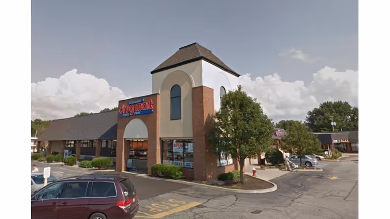 Discount Drug Mart storefront with brick facade and parking lot.