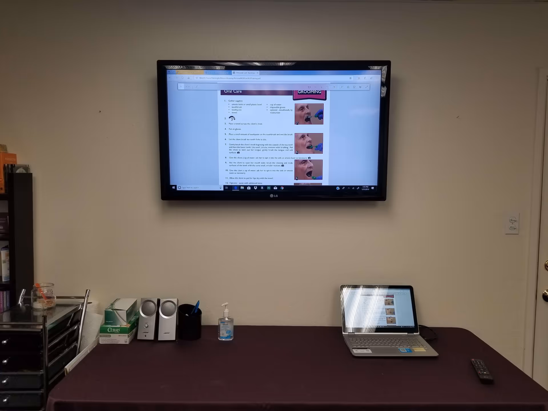 A desk setup on a maroon table inside a Home Instead facility.