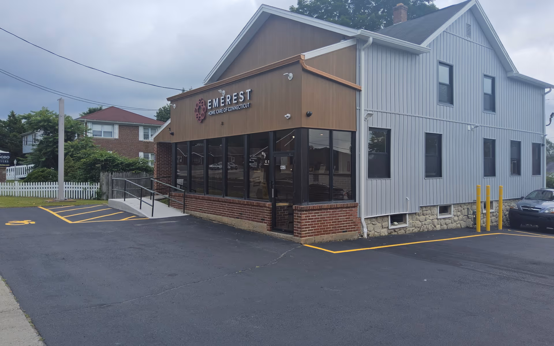 Exterior view of Emerest Home Care of Connecticut facility with glass storefront and parking.