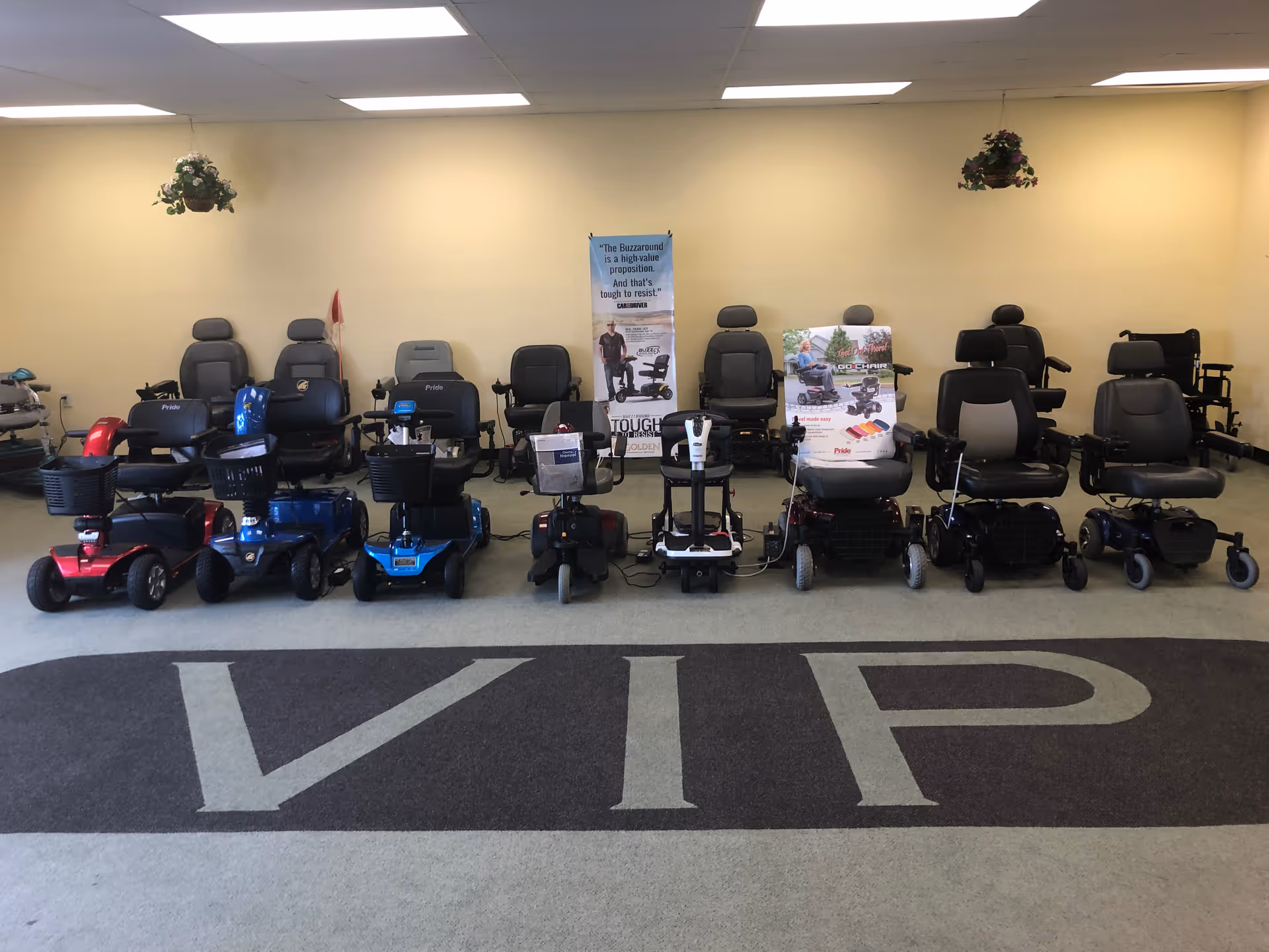 Rows of mobility scooters lined up inside a VIP Scooters showroom