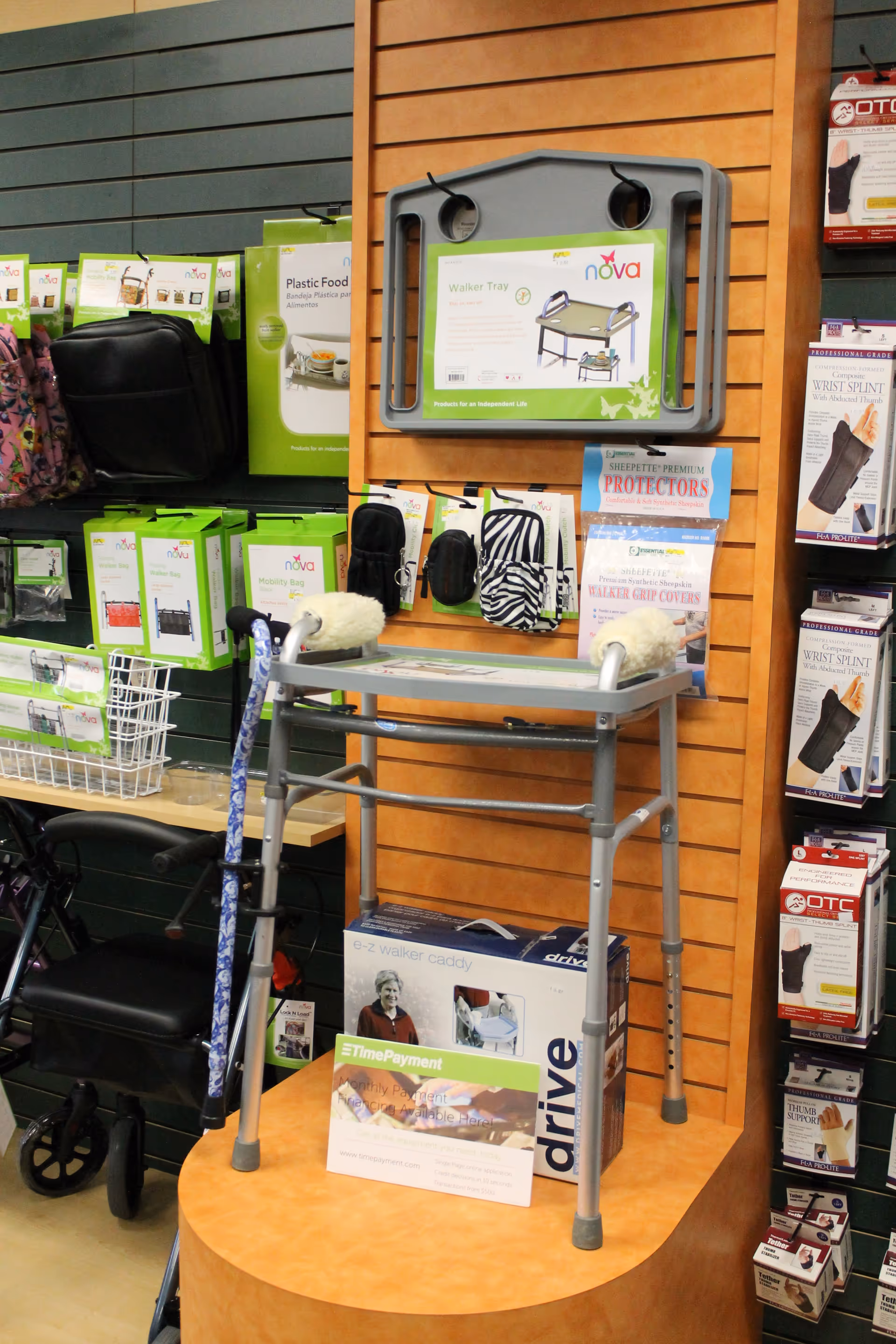 Walker on a pedestal display with medical supplies nearby.