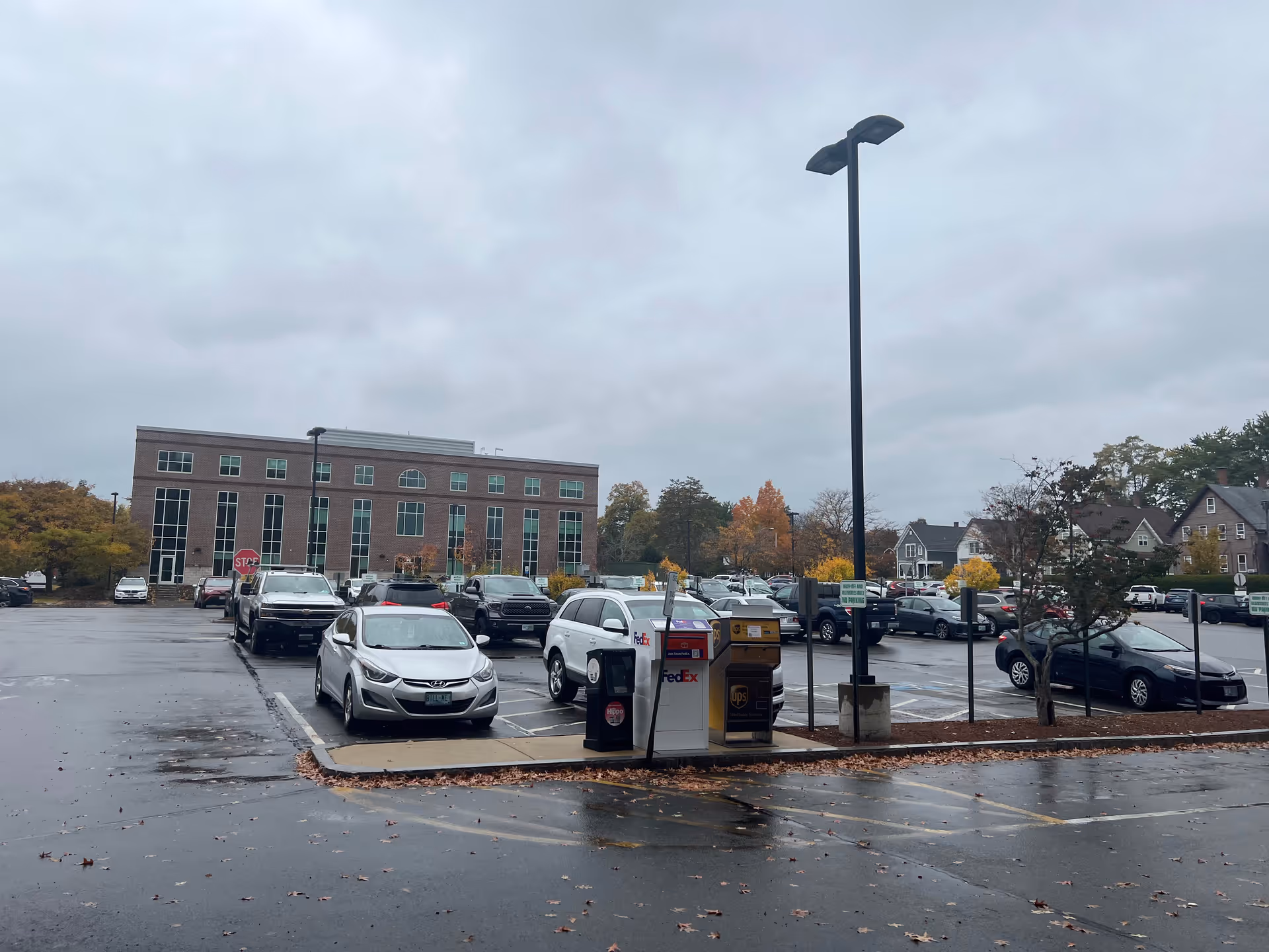 Exterior view of Granite VNA building with a wet parking lot and parked cars