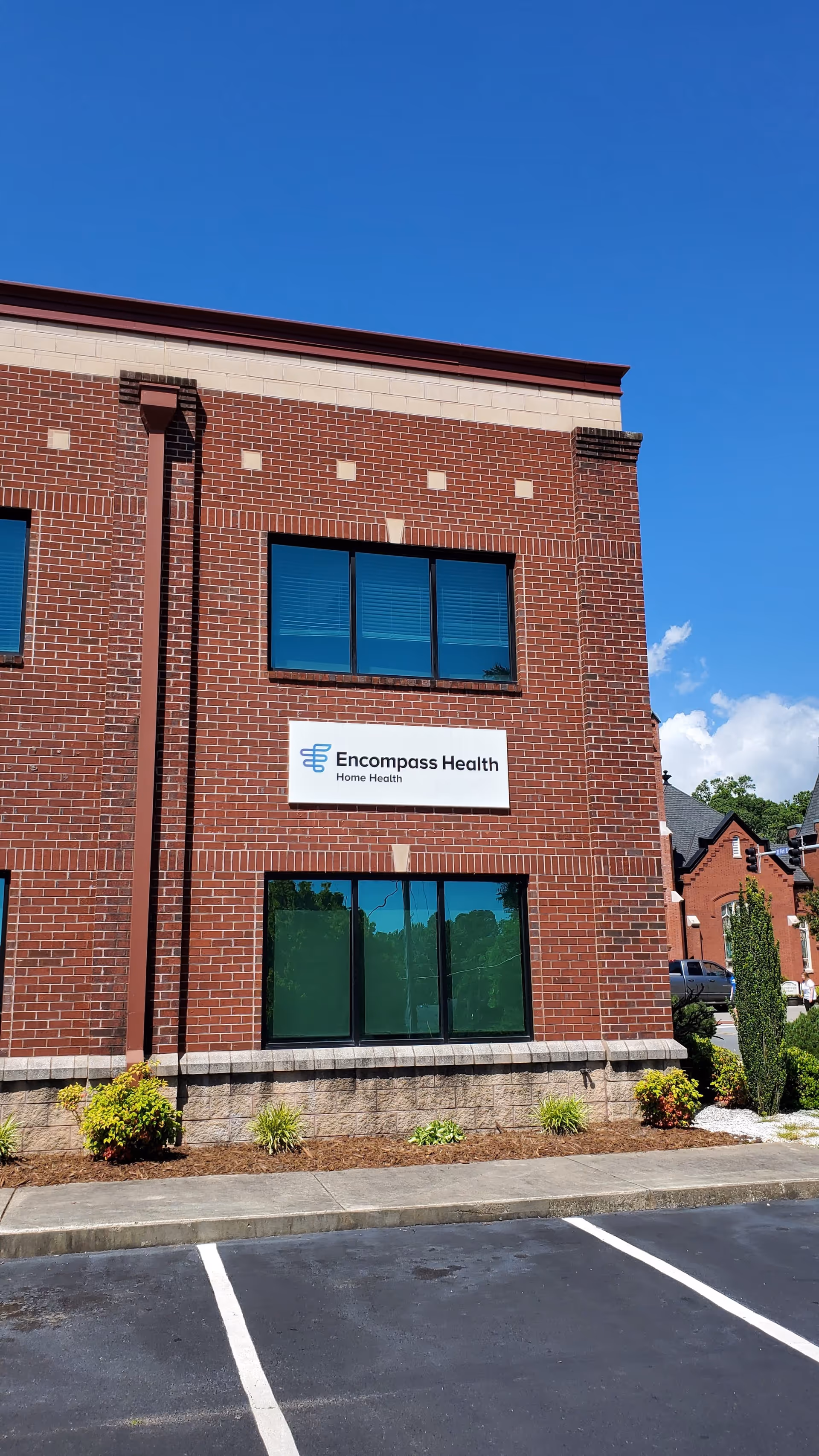 Exterior brick building with Encompass Health Home Health sign on the facade.